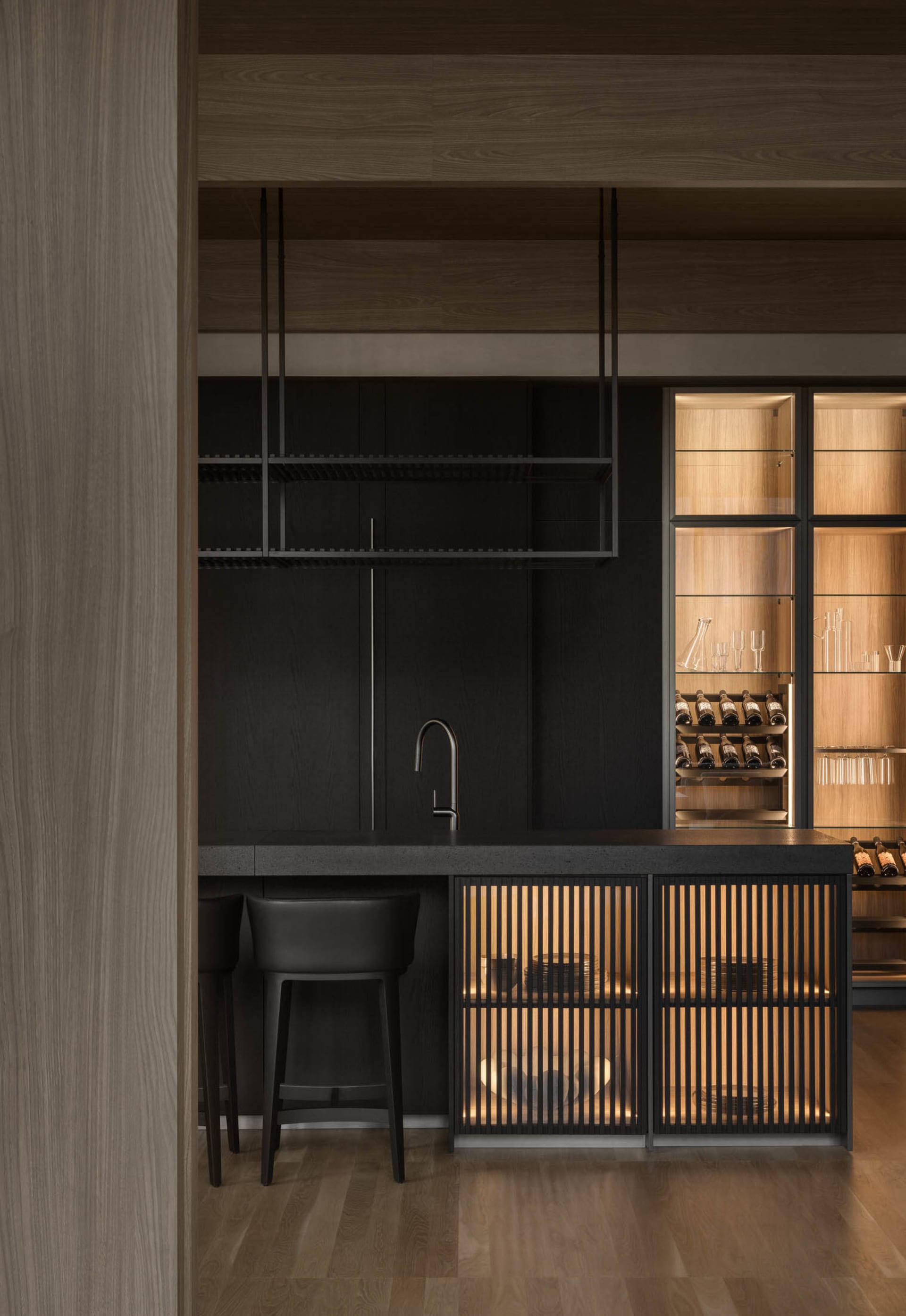 A modern wine bar with black metal elements and glass shelves.