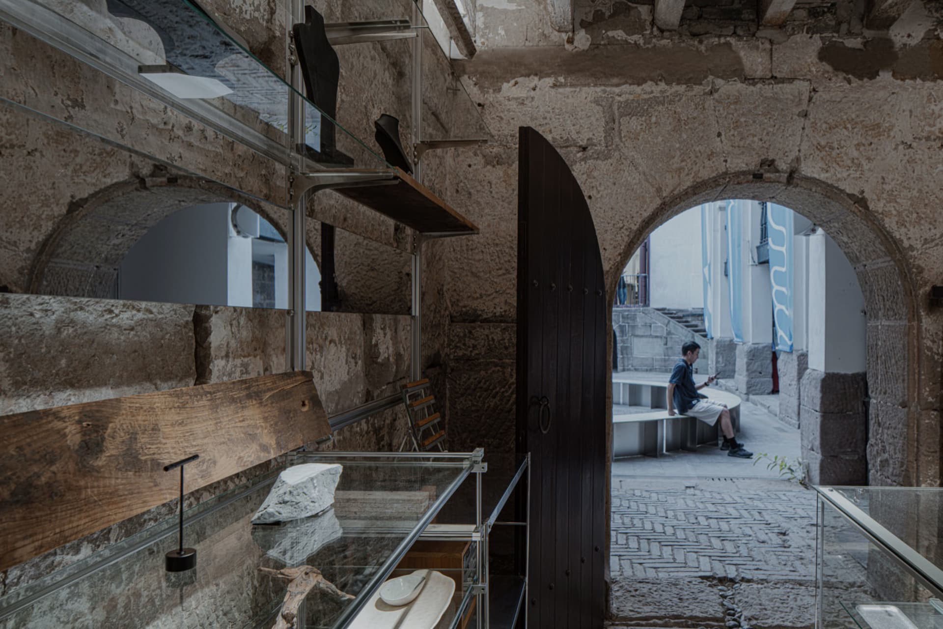 Stone museum interior with industrial design elements and archways.