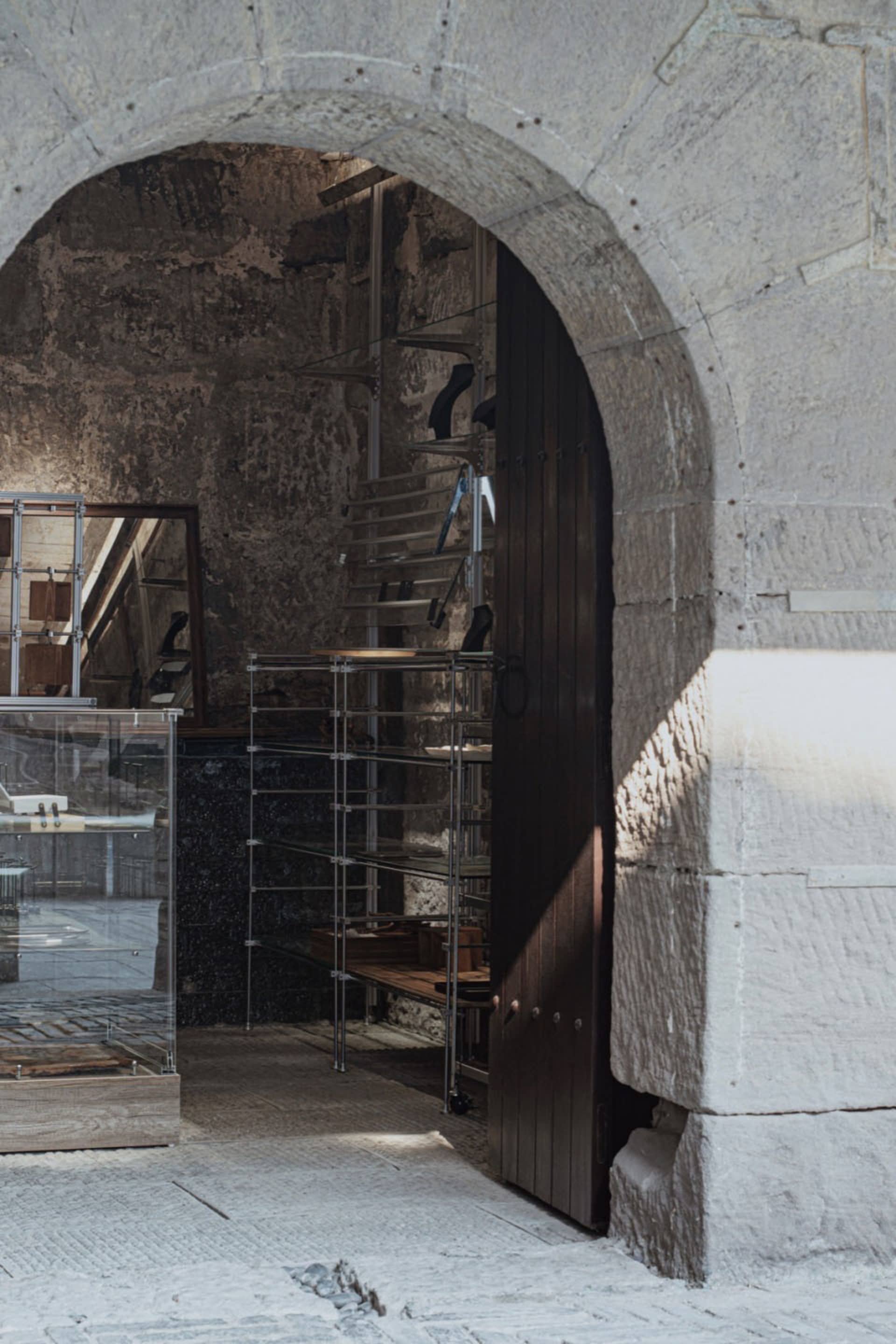 Industrial storefront with metal shelves and glass display cases.