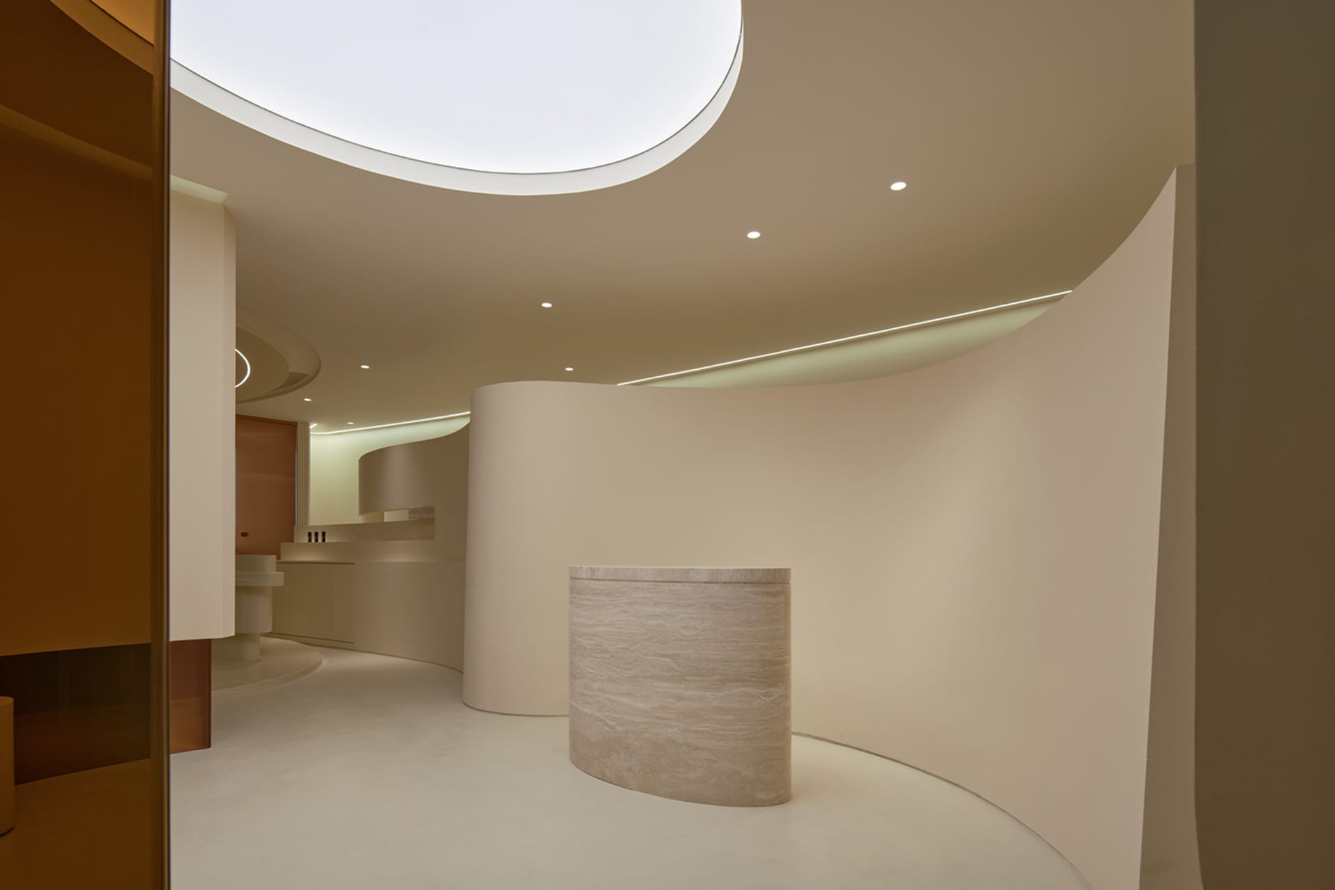 A minimalist reception area featuring curved marble walls designed to impress clients.