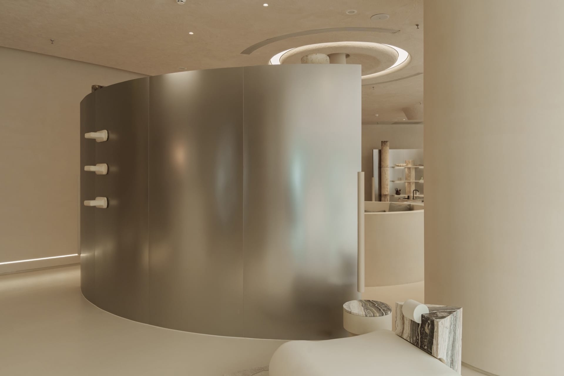 A modern spa room featuring glass walls and marble accents