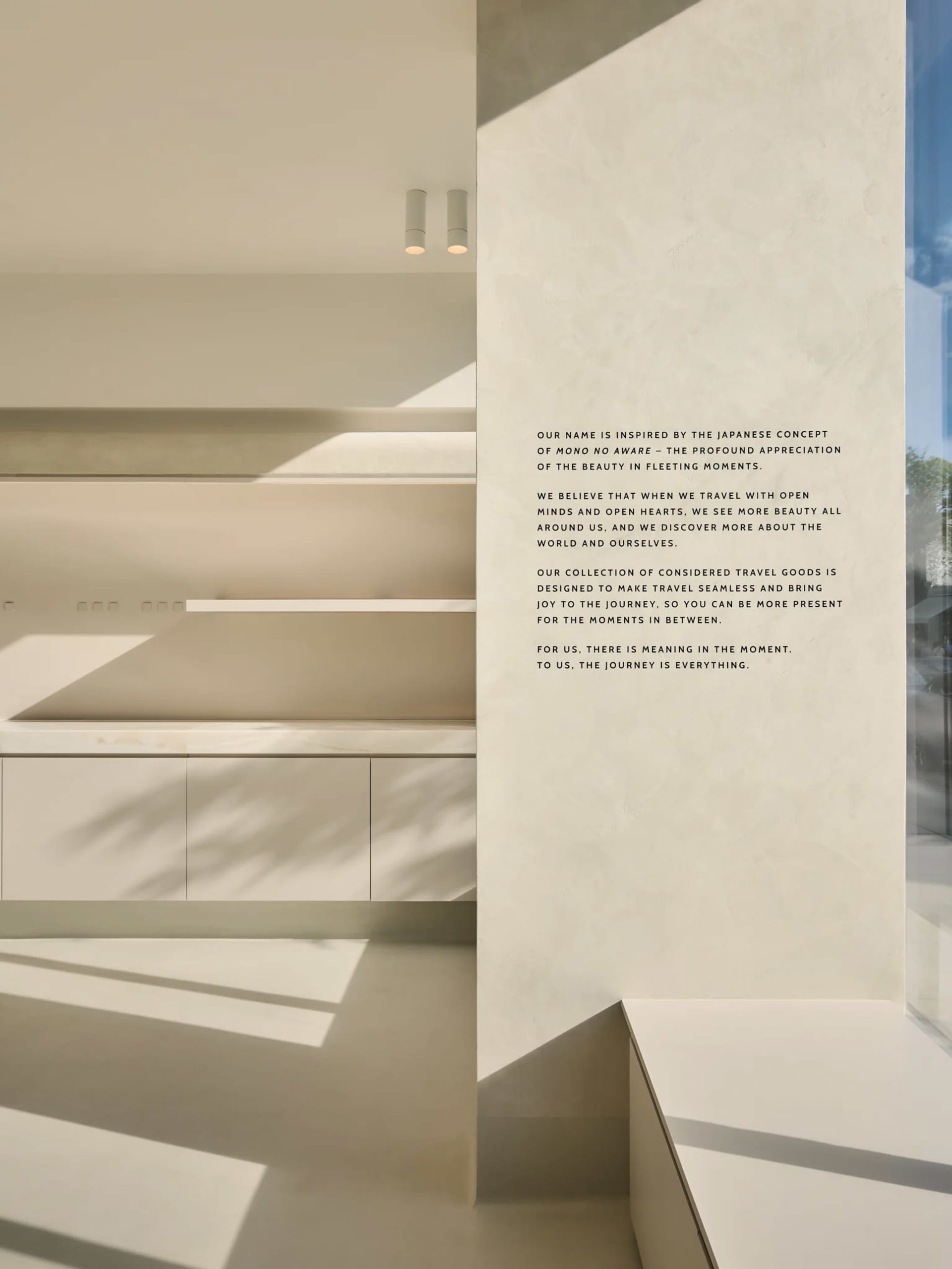 A modern travel goods store featuring minimalist design with concrete and glass materials.