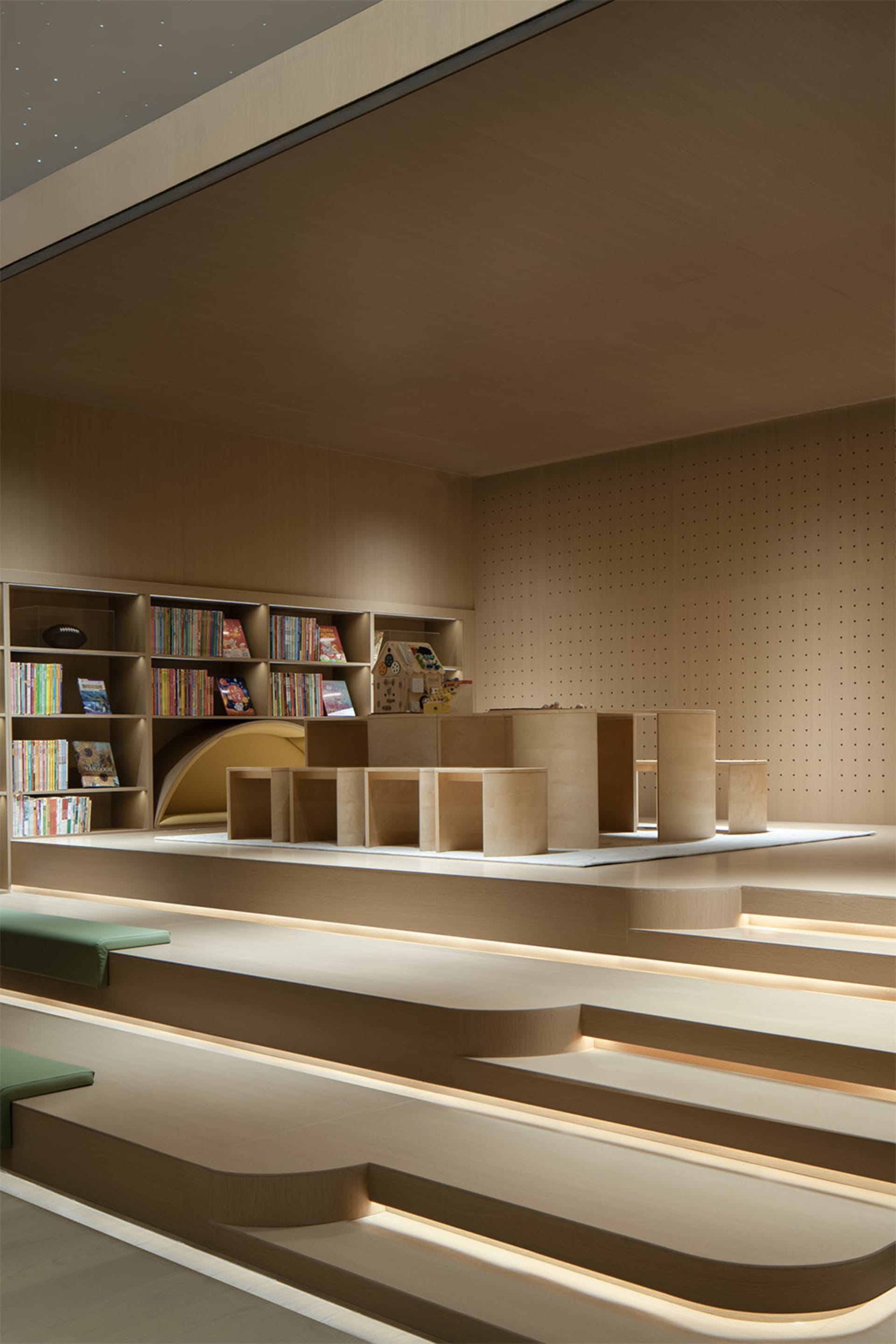 Modern library interior with wooden shelves and steps