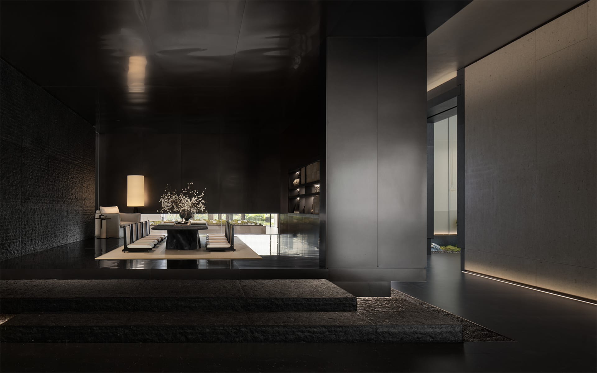 A modern living room with a concrete floor, glass walls, and minimalist decor.