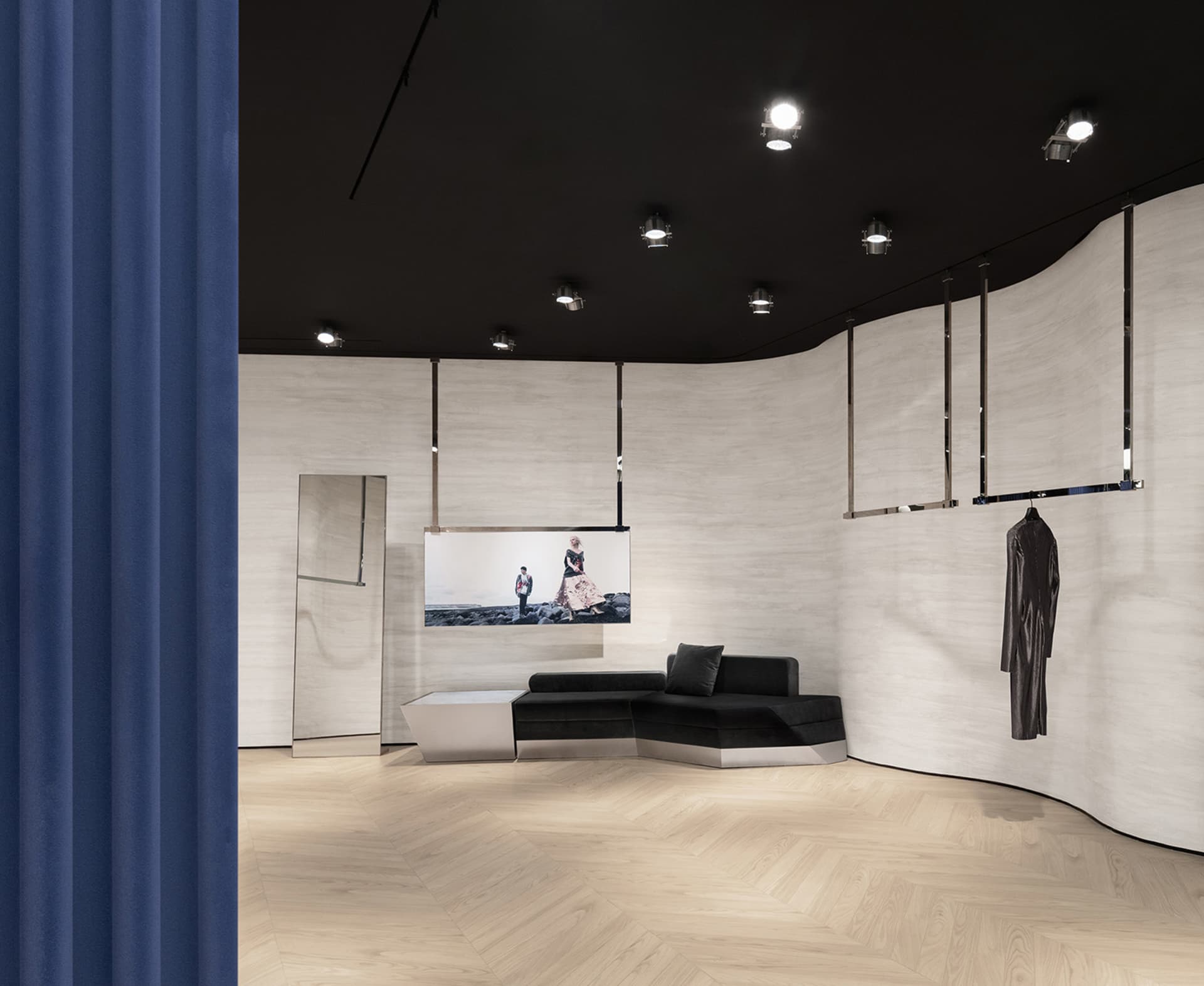 A modern retail storefront featuring metallic and fabric elements on a wooden floor.