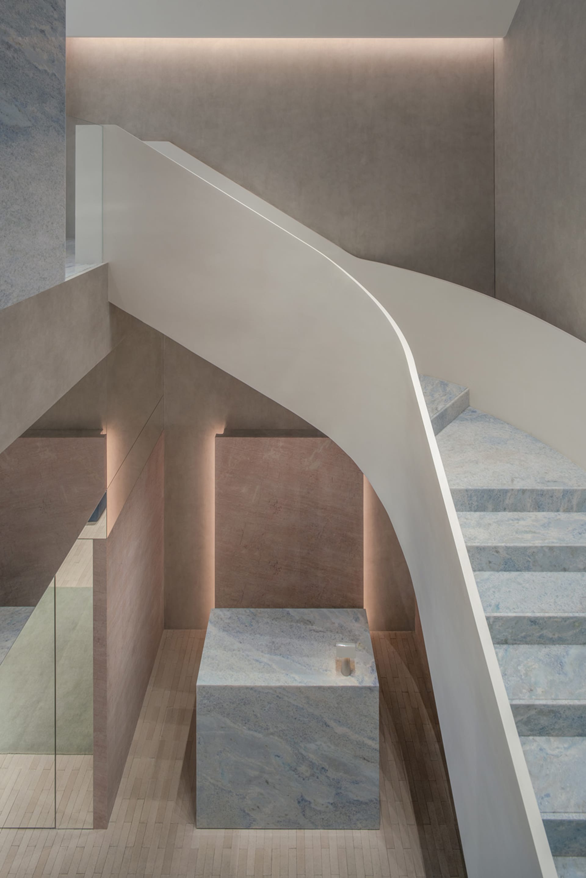 Modern minimalist staircase with marble steps and concrete wall and floor