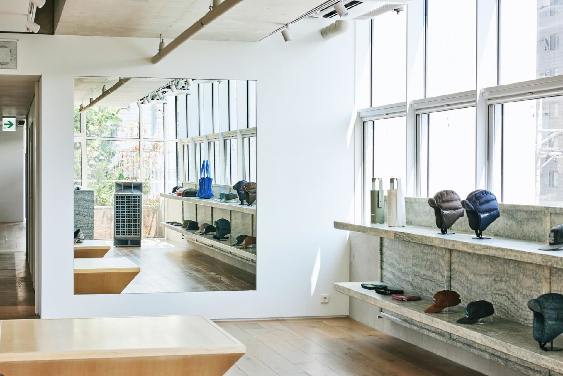 Modern storefront interior displaying products on shelves with wood and granite surfaces.
