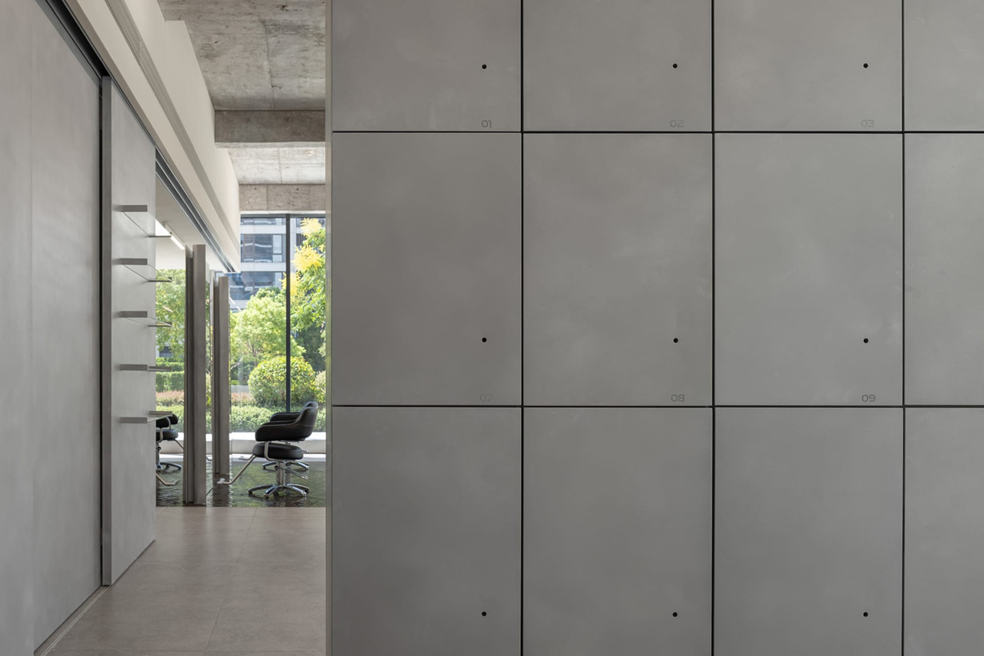 Minimalist living space featuring sleek concrete walls and modern furniture.