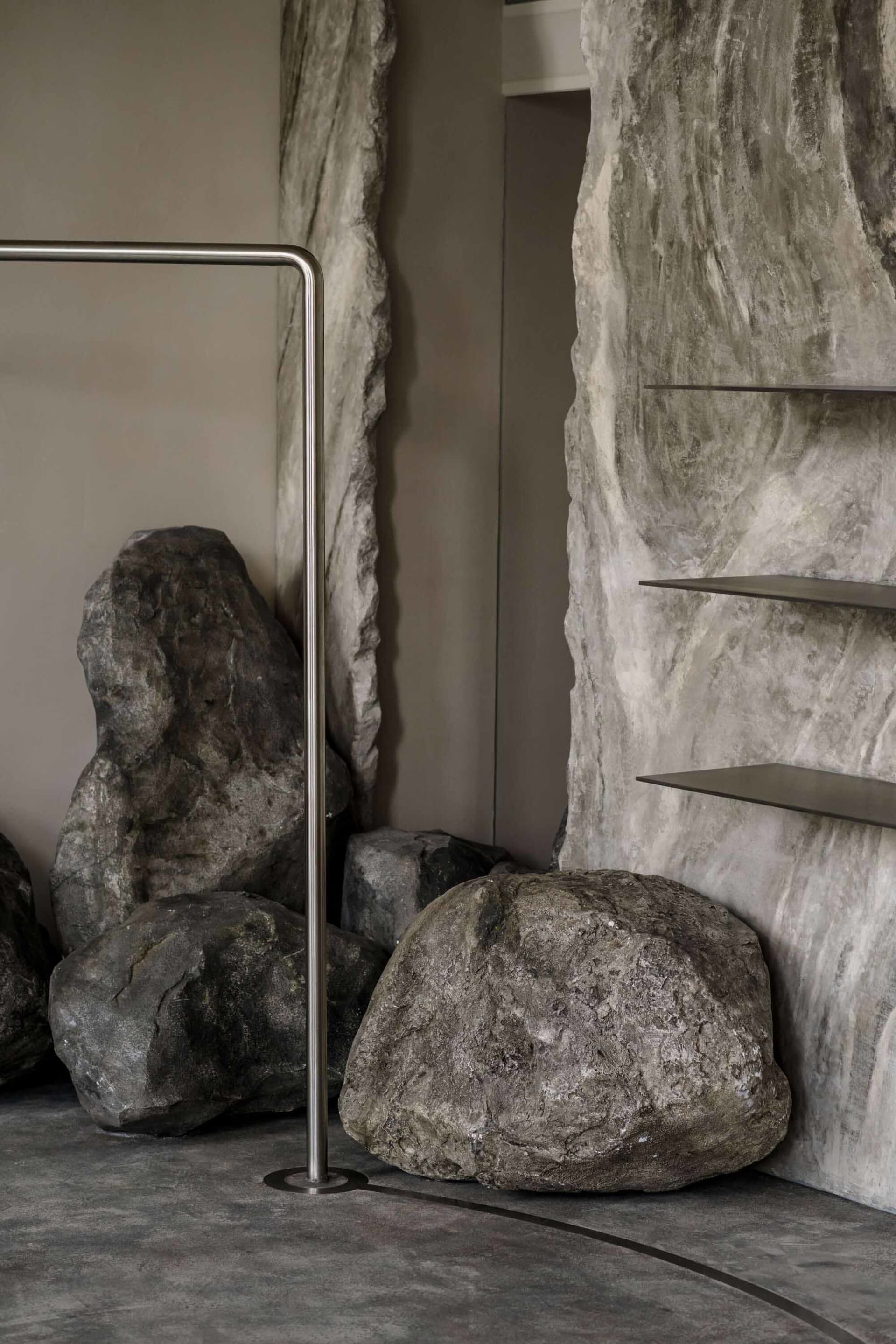 Modern minimalist furniture display featuring metal and concrete materials.