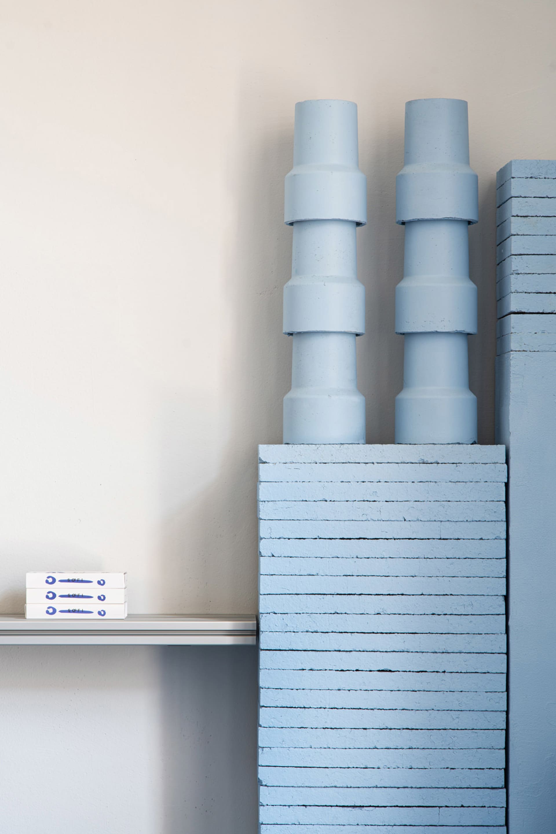 A minimalist shelf made of concrete blocks.