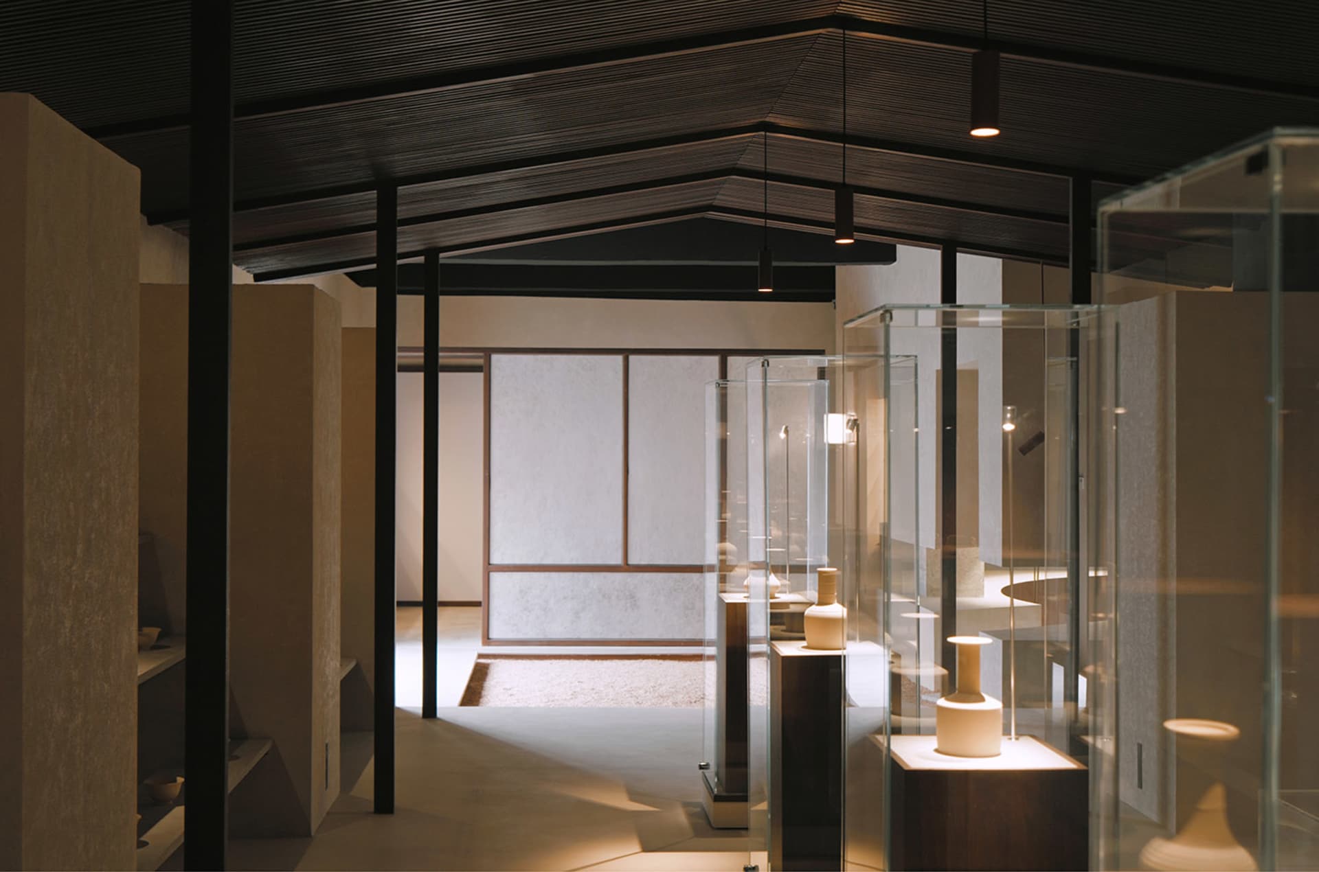 A modern interior design featuring a glass display case in a museum exhibit setting.