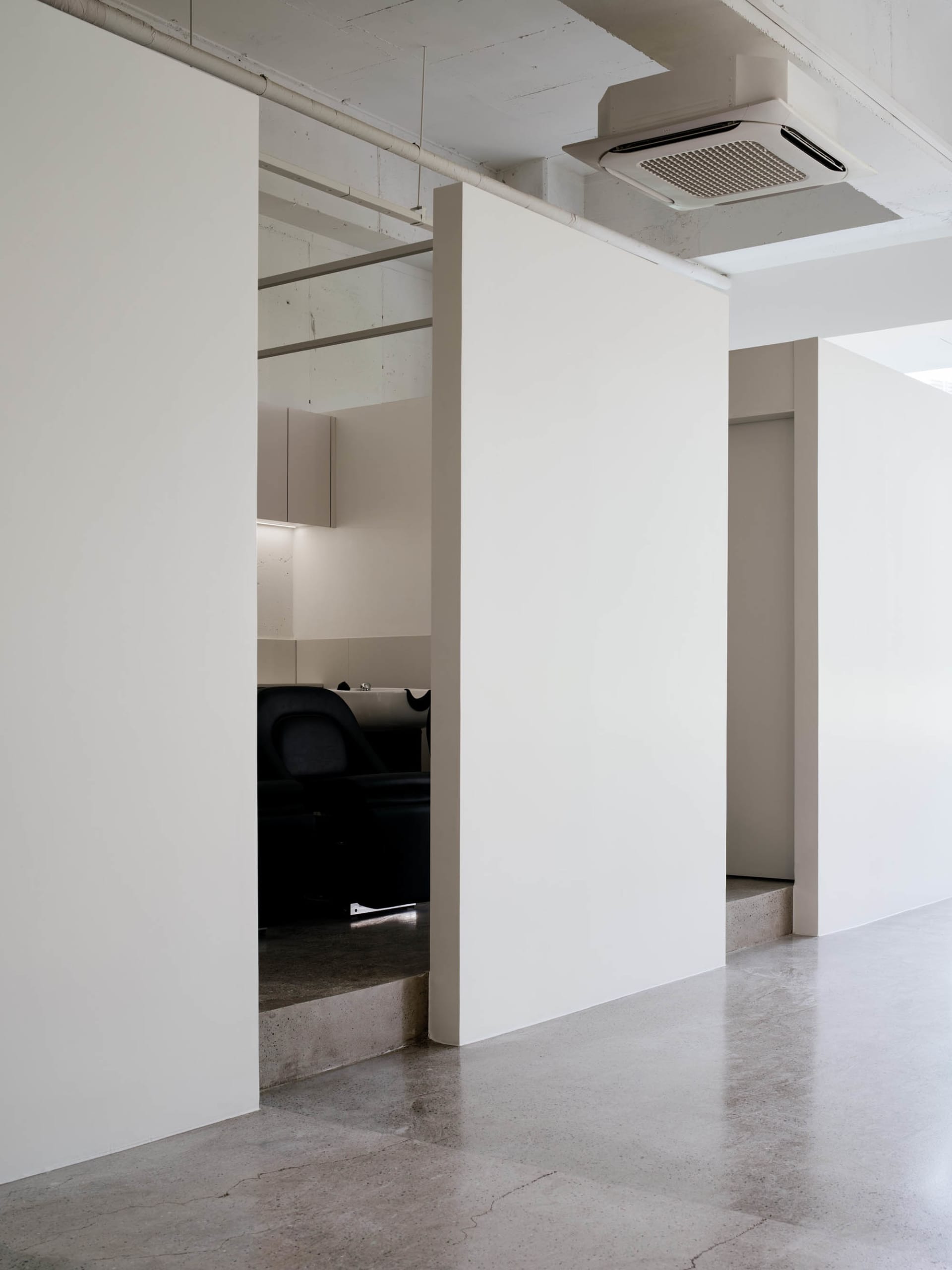 A modern office space featuring a concrete floor.