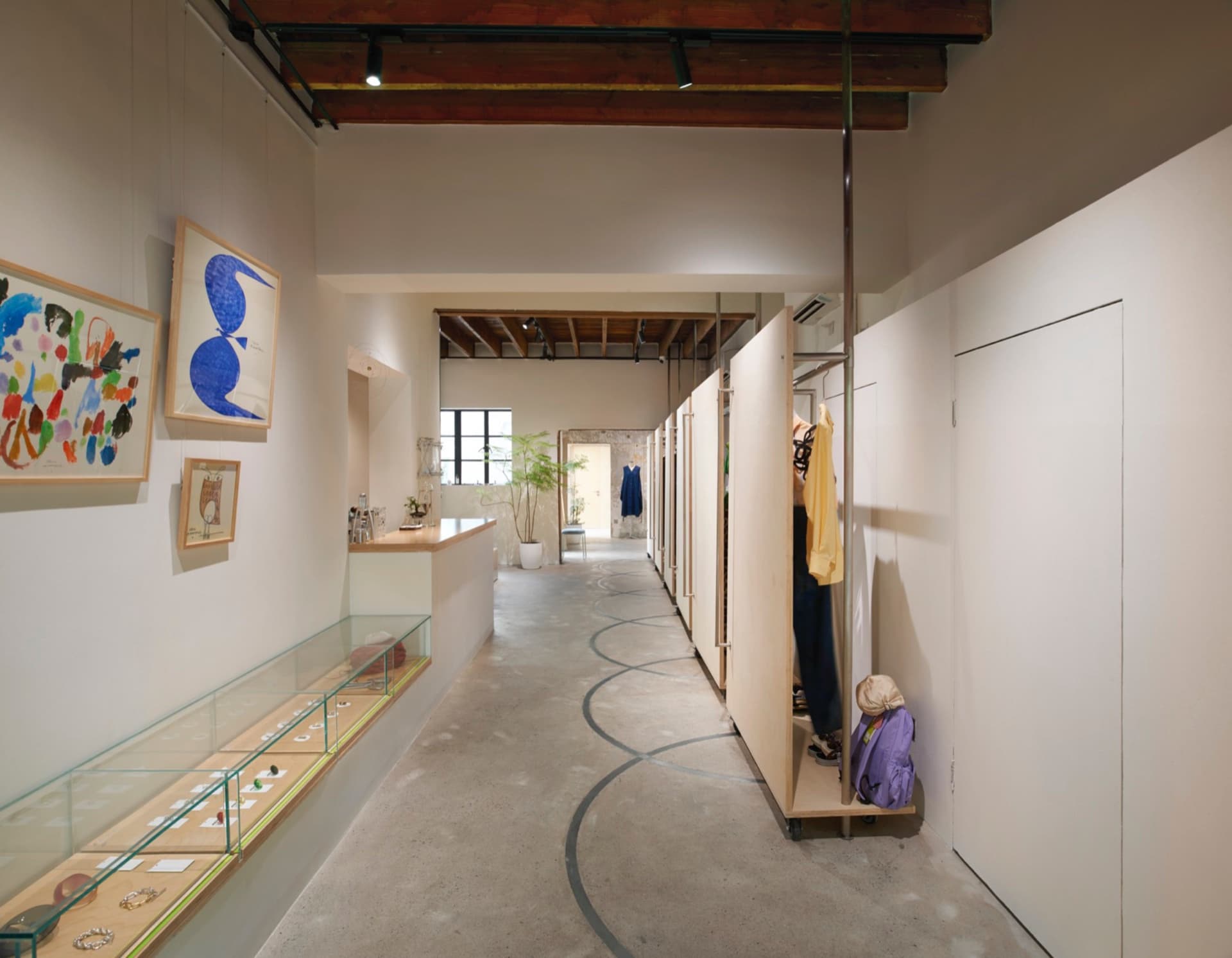 A retail storefront featuring a concrete floor and display case.