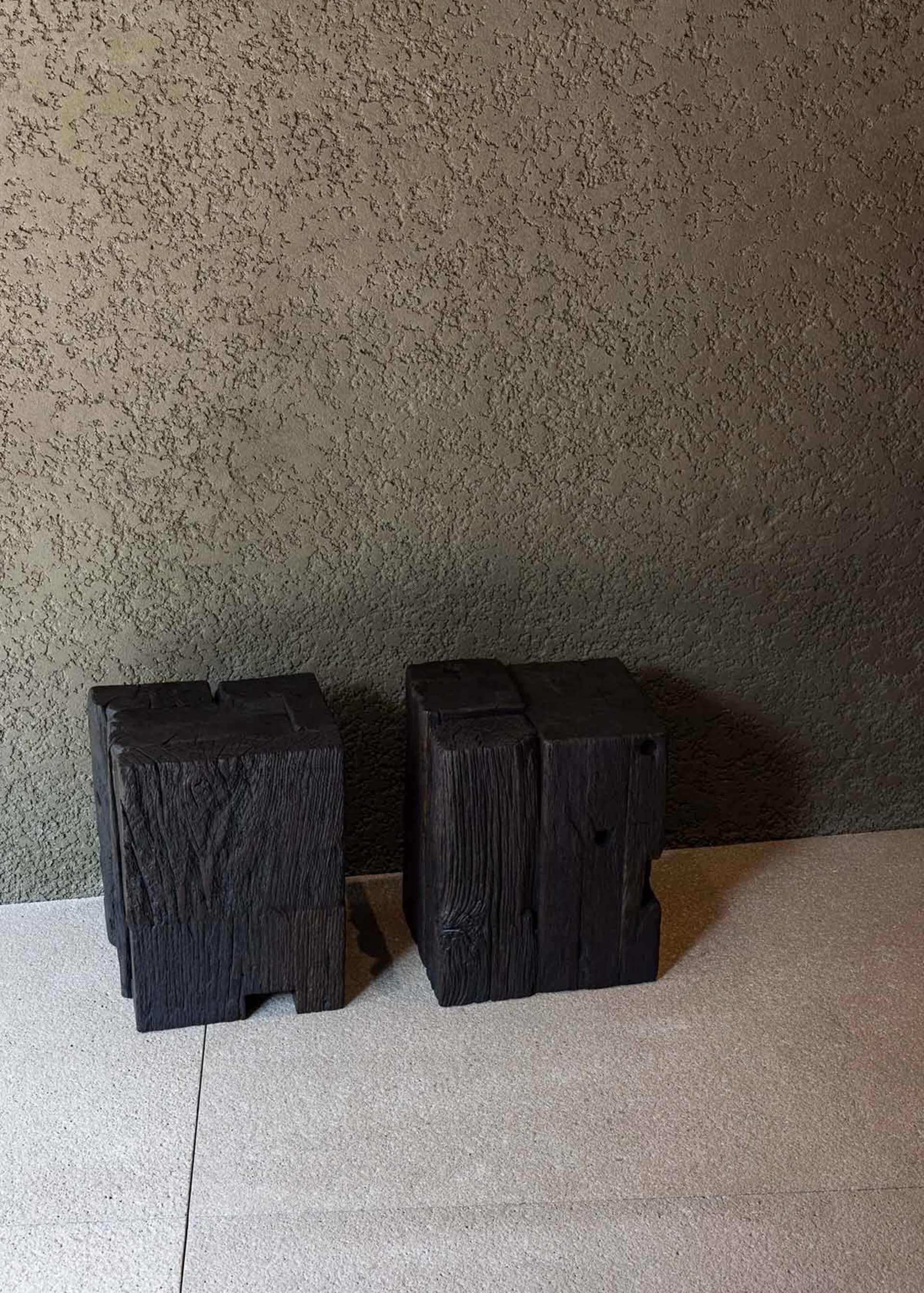 Industrial-style wooden blocks against a textured wall.
