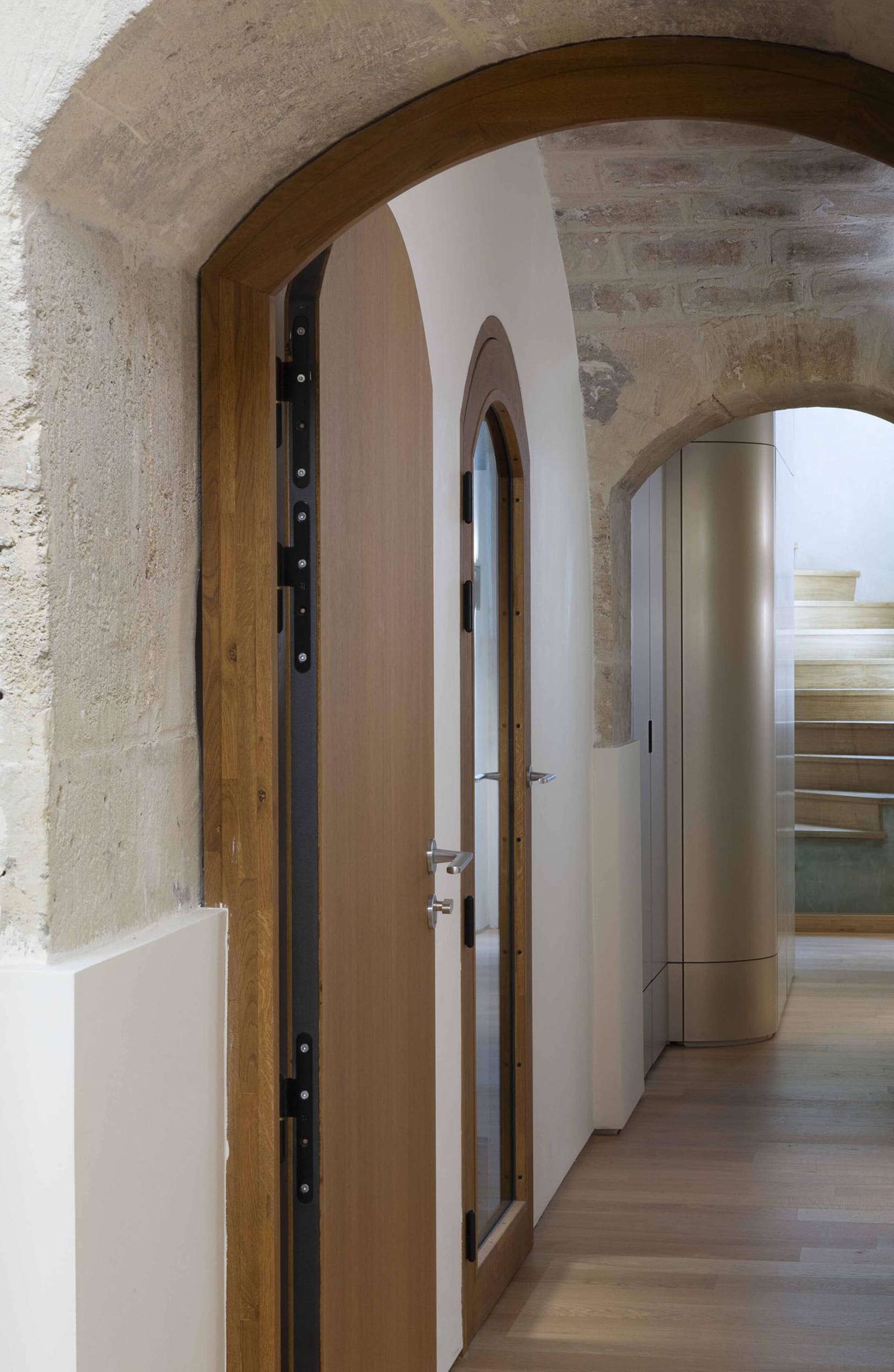 Modern hallway with wooden doors and glass panel