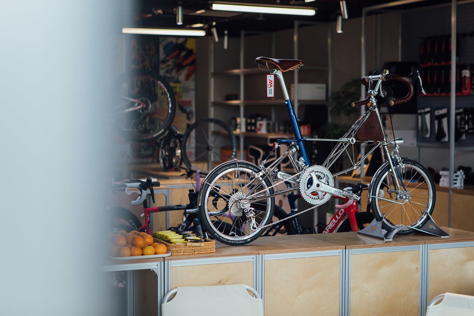 An industrial design retail bike shop showcases a metallic bicycle on display.