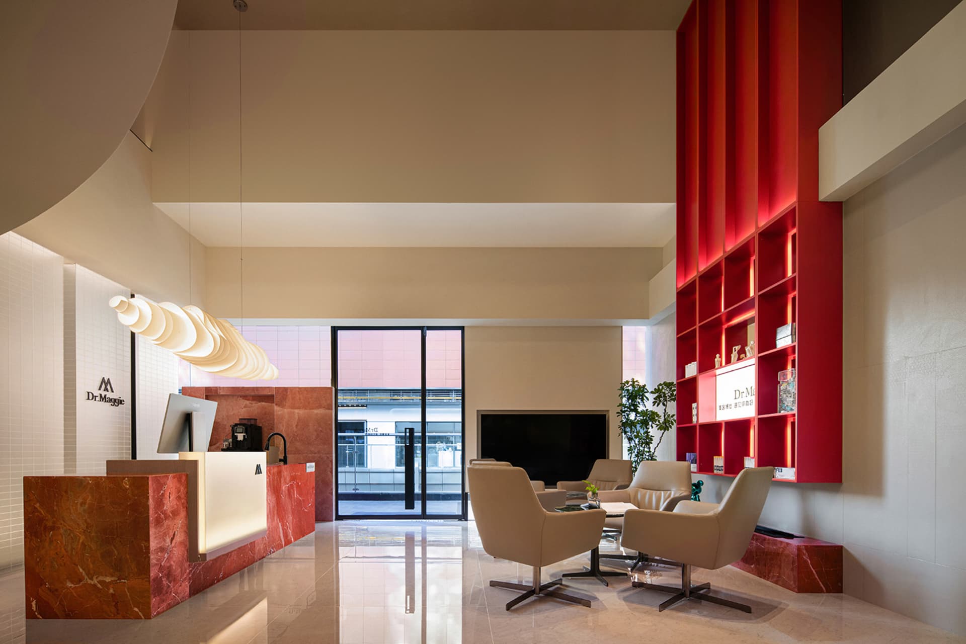 A modern lobby with glass walls, black marble countertops, and porcelain tiled floors.