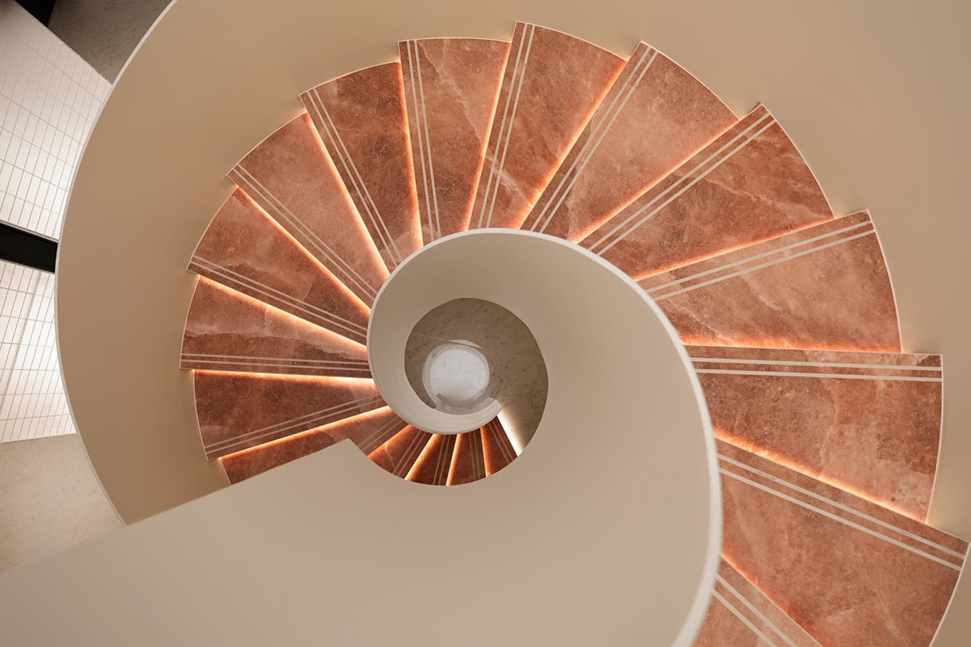 Spiral staircase made of marble with a circular design.