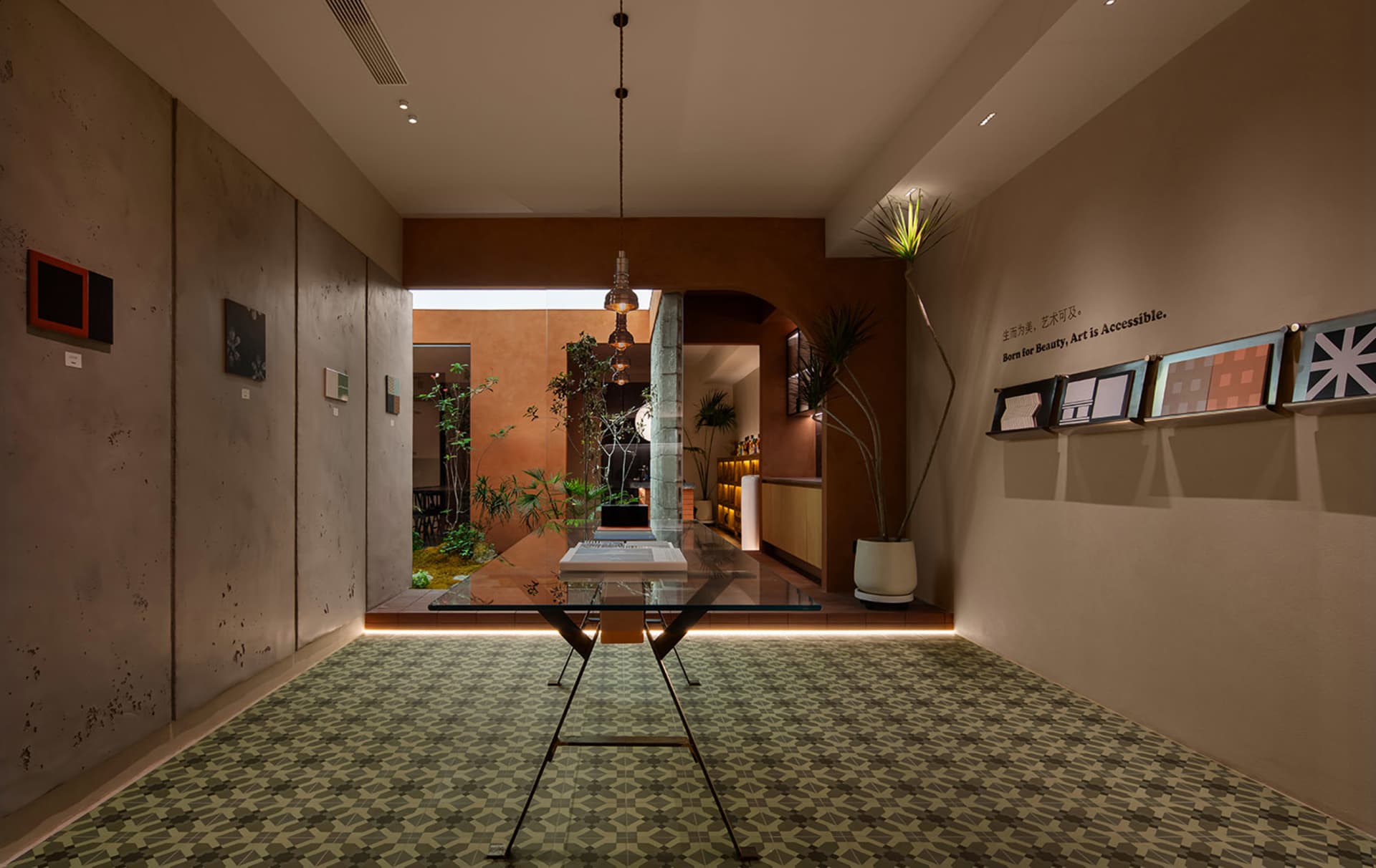 A modern lobby with a contemporary concrete design, featuring minimalist furniture and a green plant.