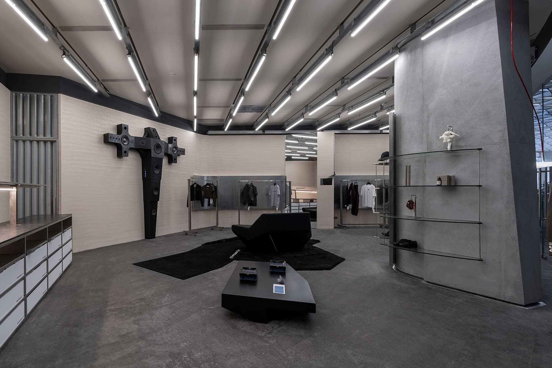 Modern retail storefront featuring concrete, metal, glass, and leather materials.