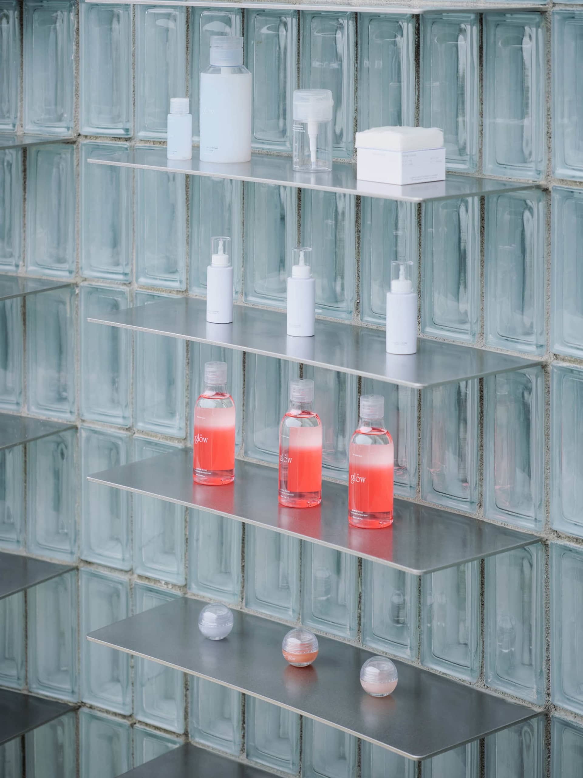 Shelves in a retail environment displaying beauty products in a sleek, modern setting.