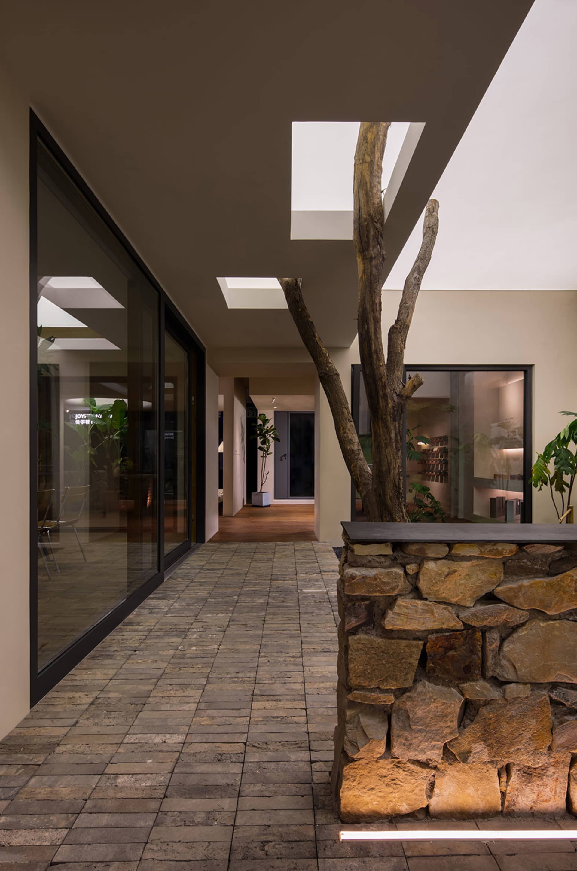 An indoor commercial space with brick walls, concrete flooring, and modern design elements.