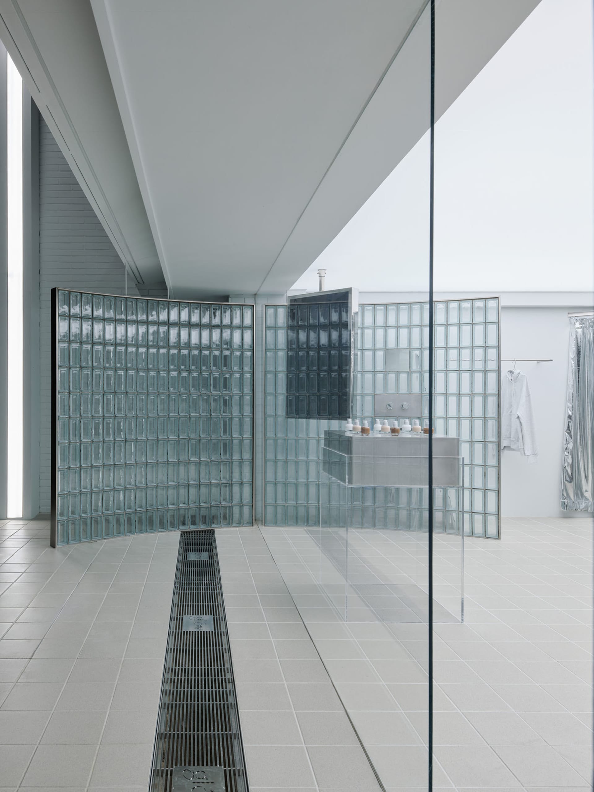 A modern bathroom with glass-block walls and a minimalist design.