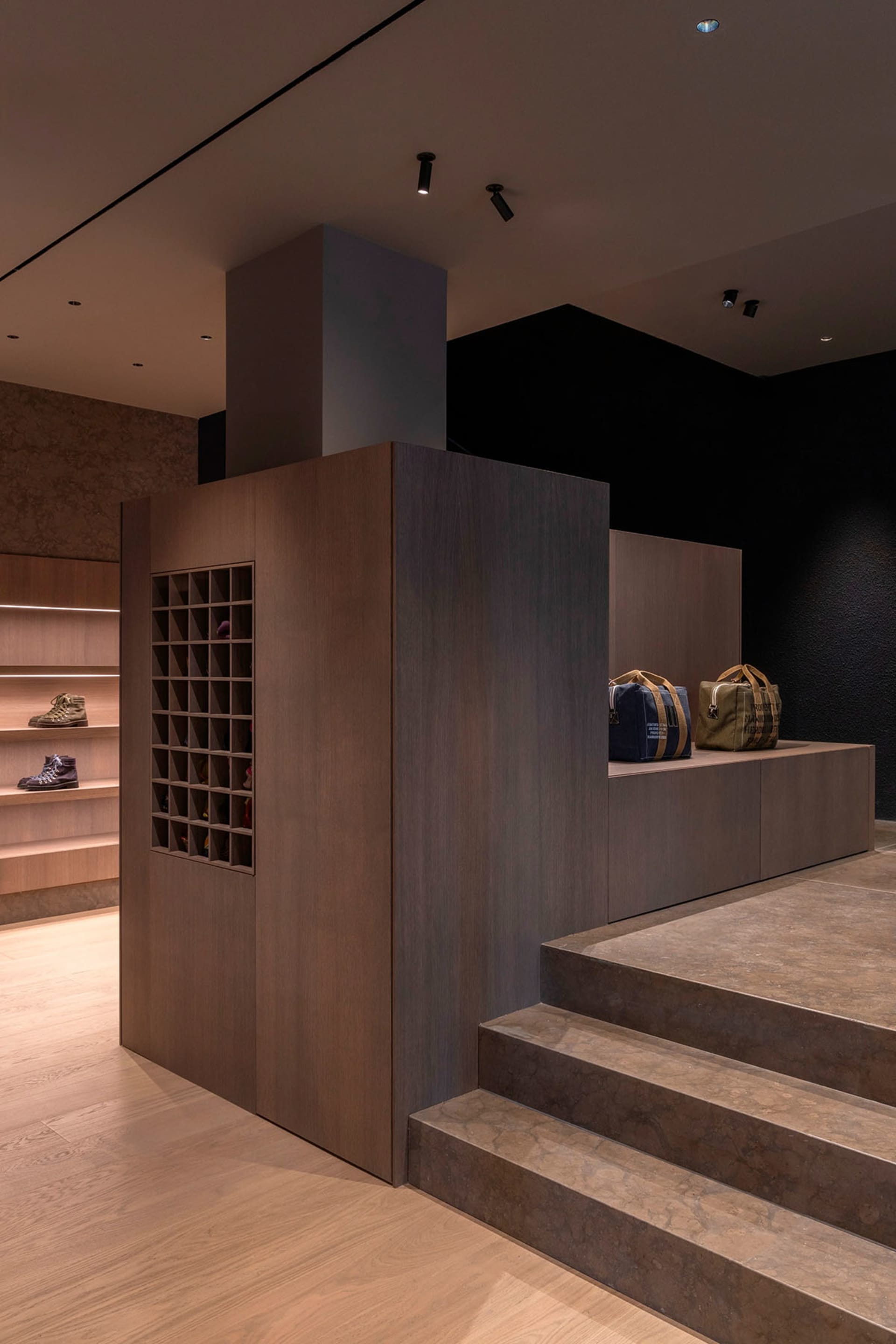 Modern retail store with wooden and concrete accents, featuring organized storage units.