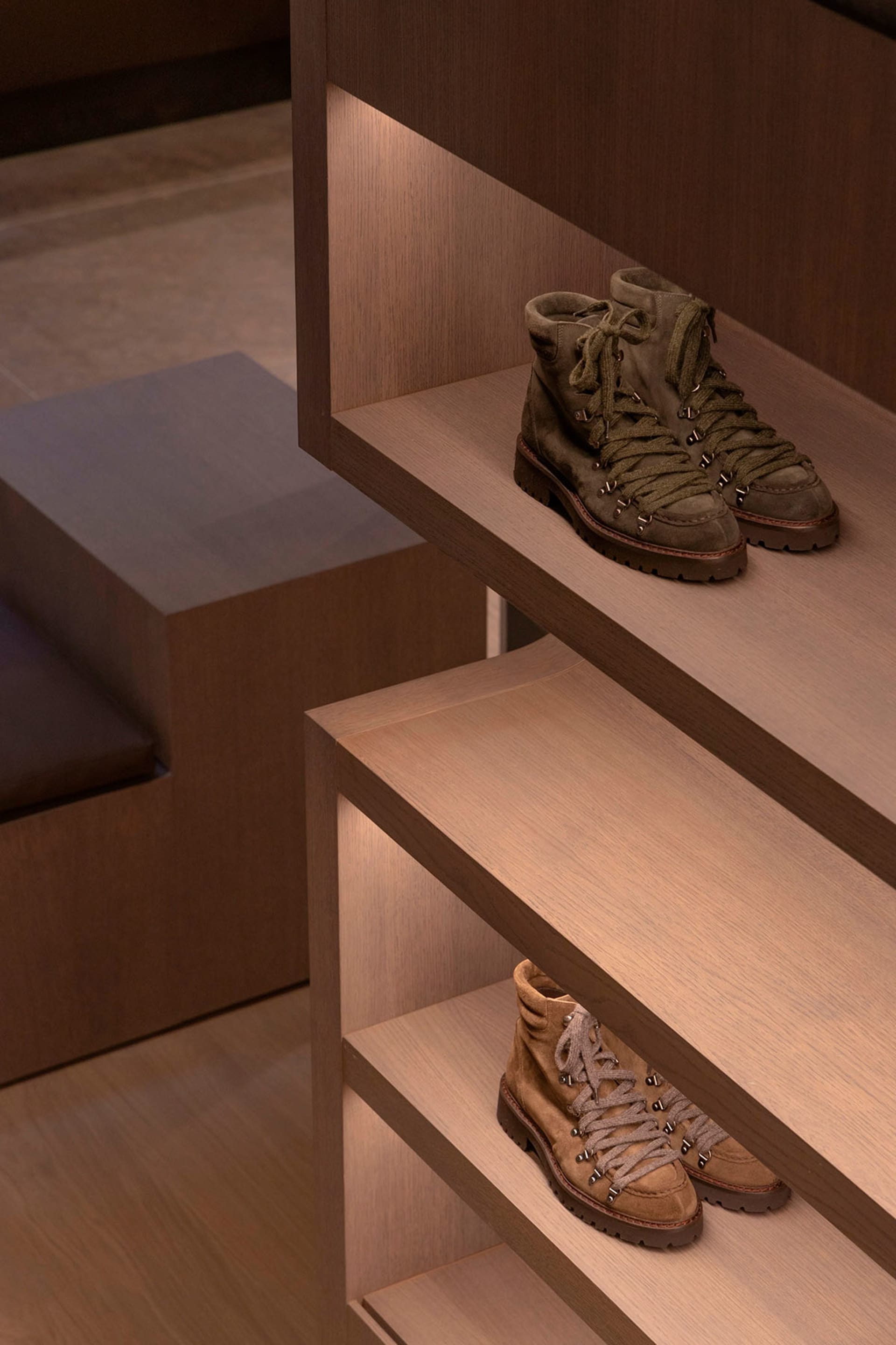 Modern, sleek shoe storage solution featuring wooden shelves with built-in lighting.