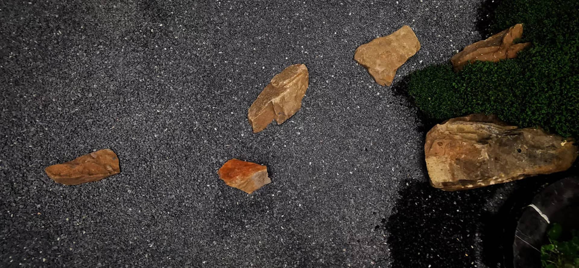 Scattered stones on a gravel ground