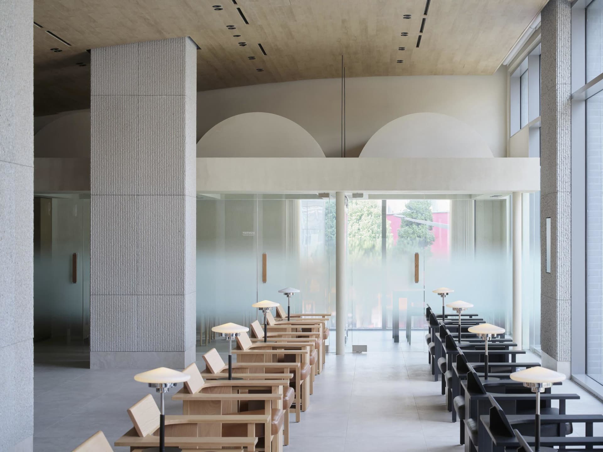 Modern, minimalist coffee shop interior with glass and wood materials.