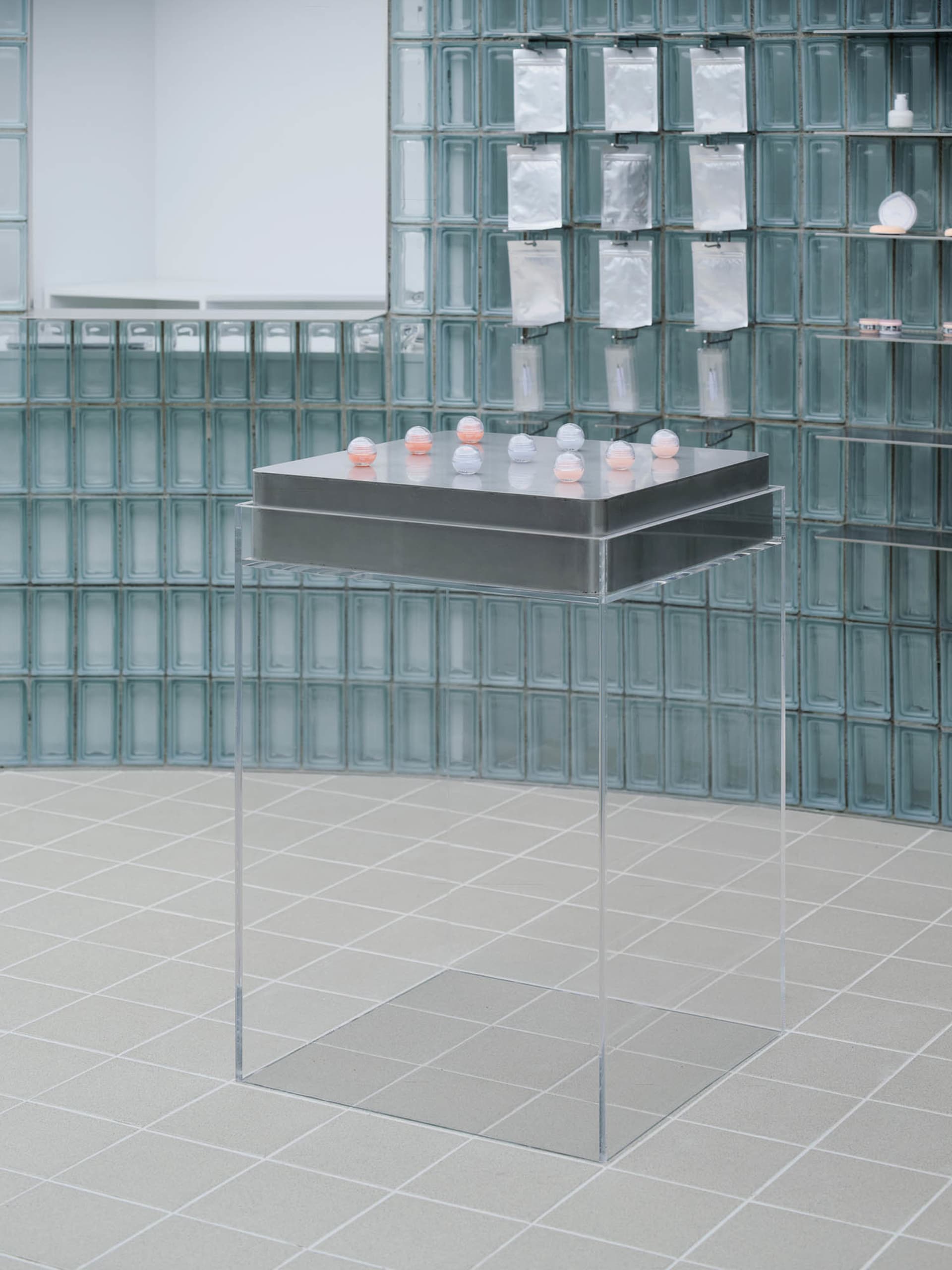 Transparent glass cubes arranged on a metallic base in a modern installation setting.