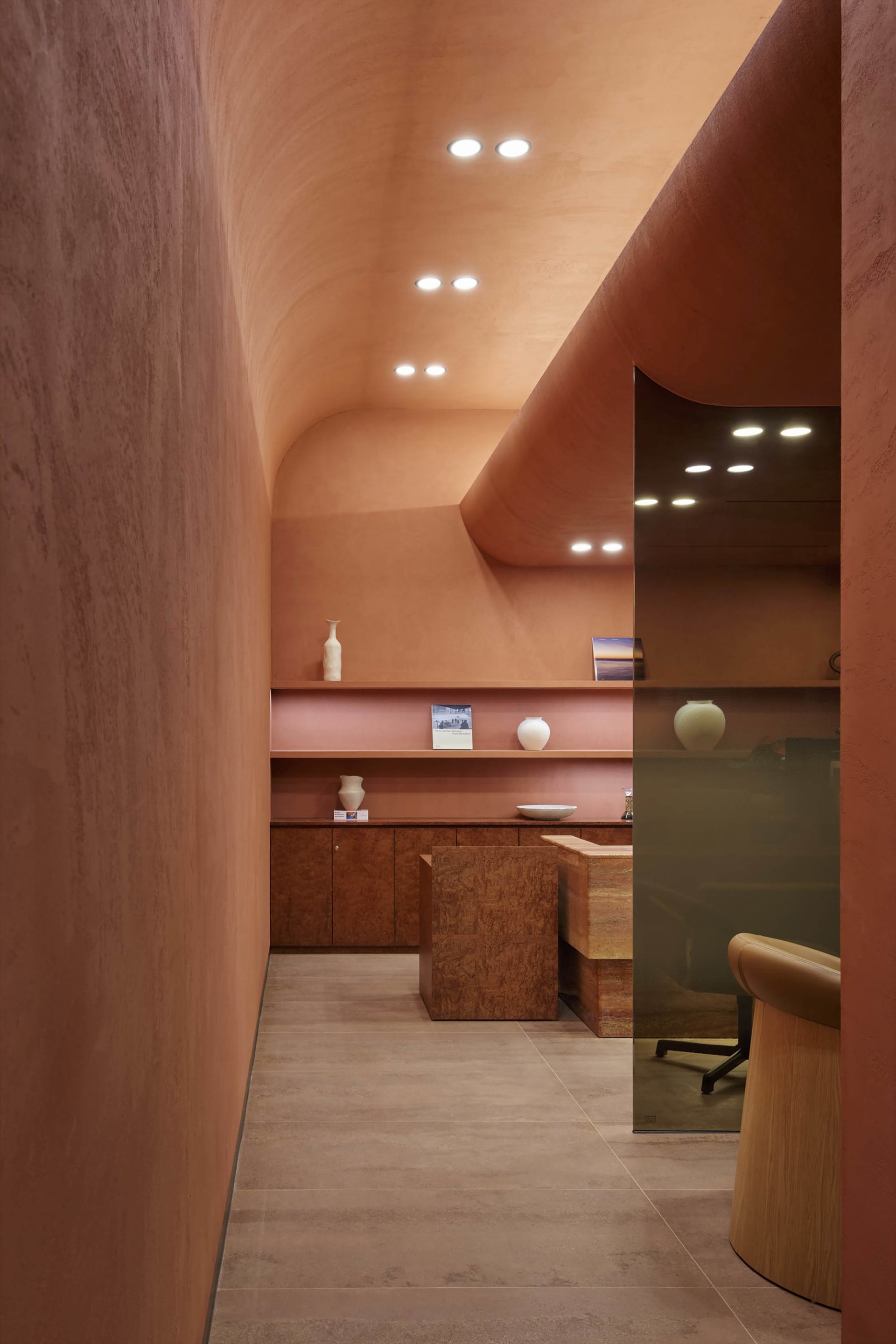 Modern interior design featuring a lobby with terrazzo and cement elements.