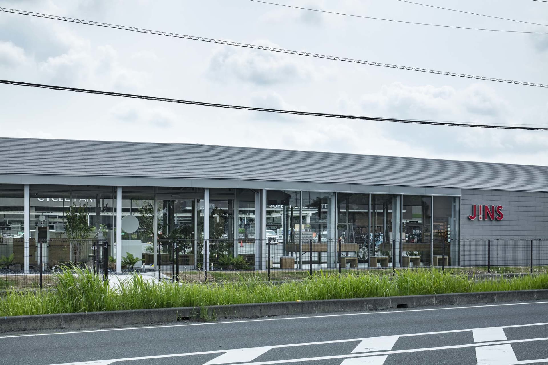 Modern glass and concrete storefront of a retail shop.