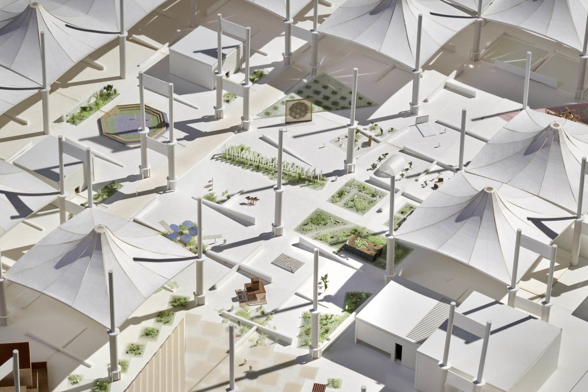 Model of a modern urban campus featuring white roofed tents arranged in a grid pattern.