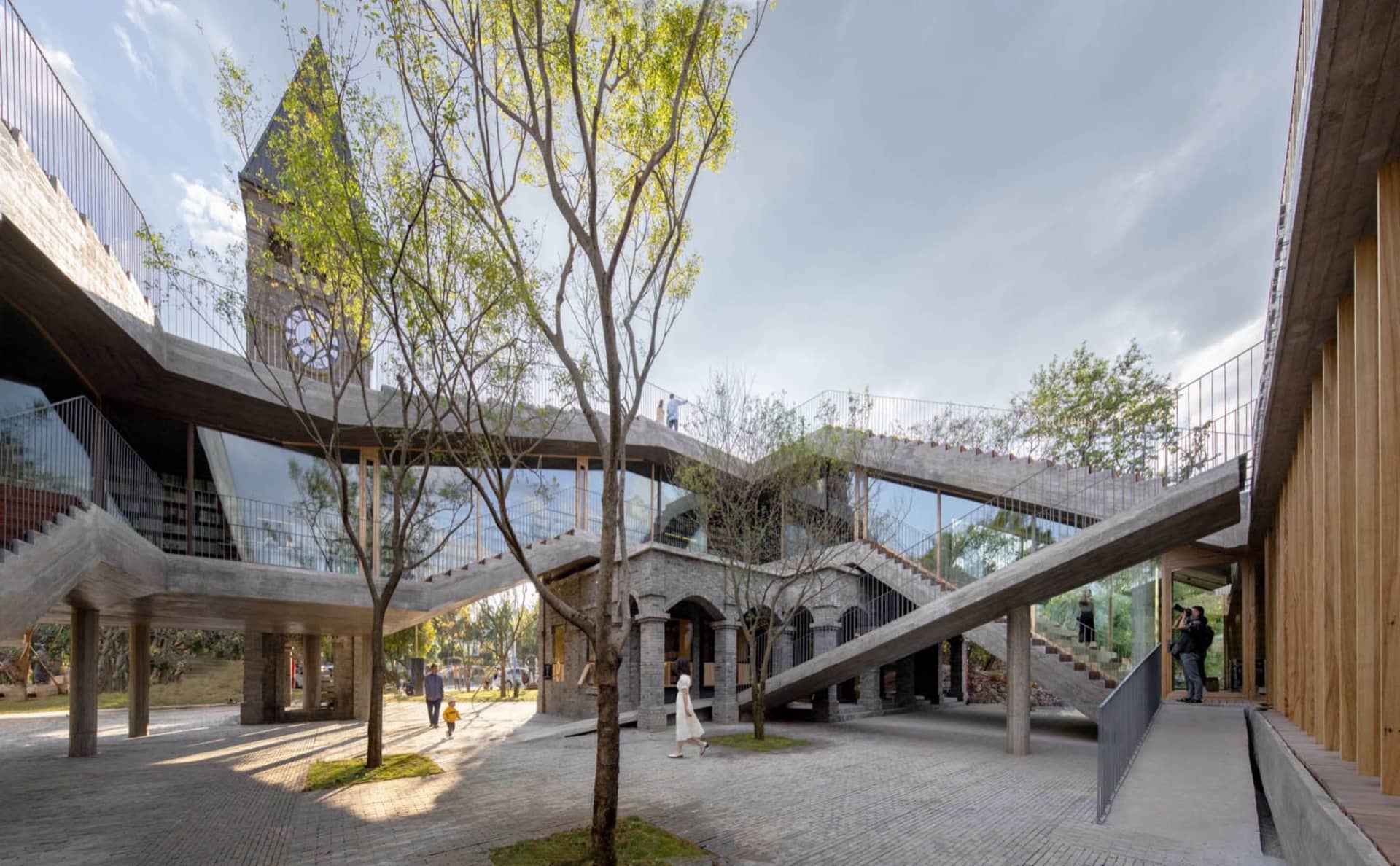 Large, modern building with concrete, glass, and wooden elements