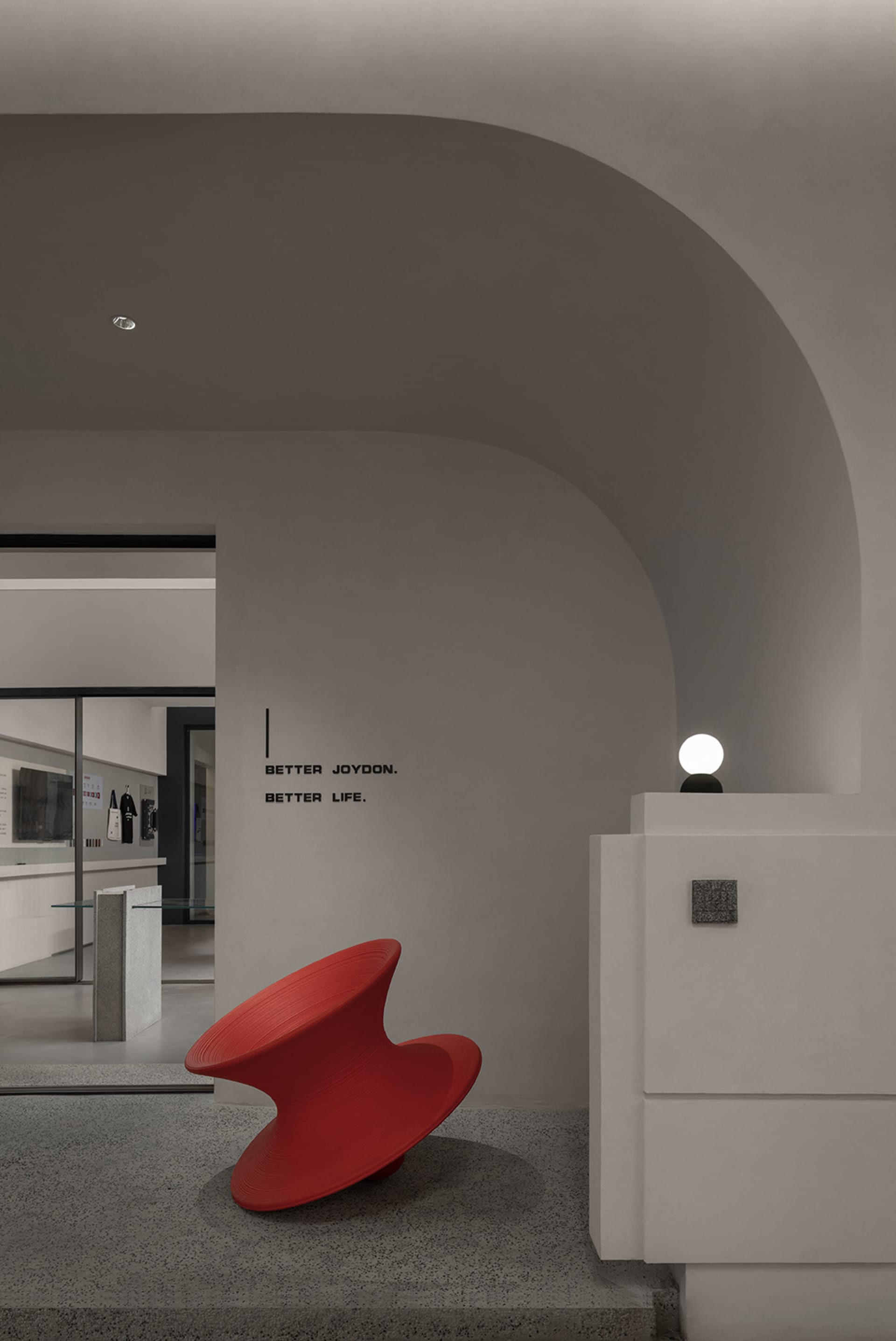 A minimalist retail storefront with a modern, sleek design featuring concrete materials.