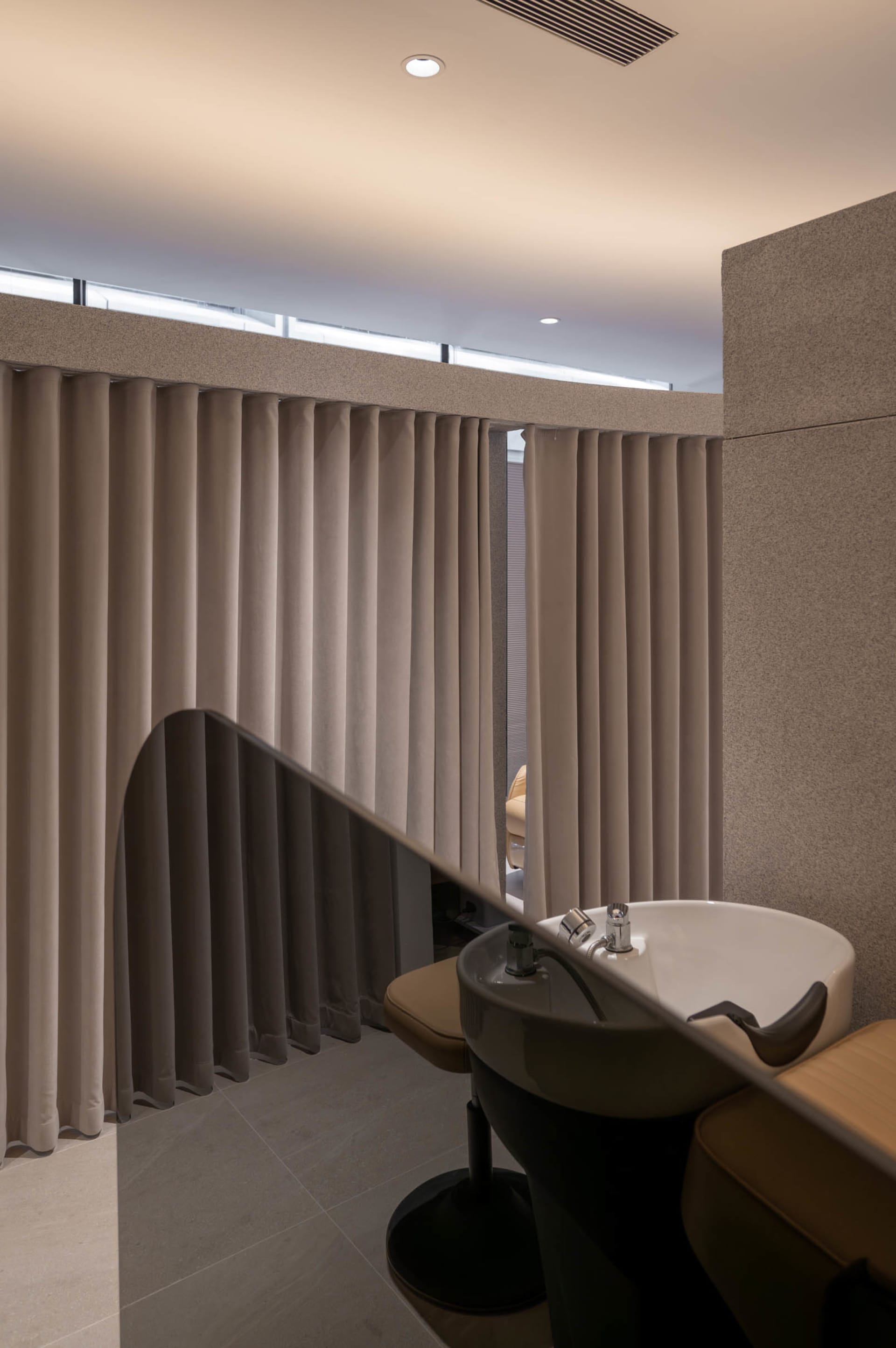 Modern bathroom featuring marble sink and contemporary curtains
