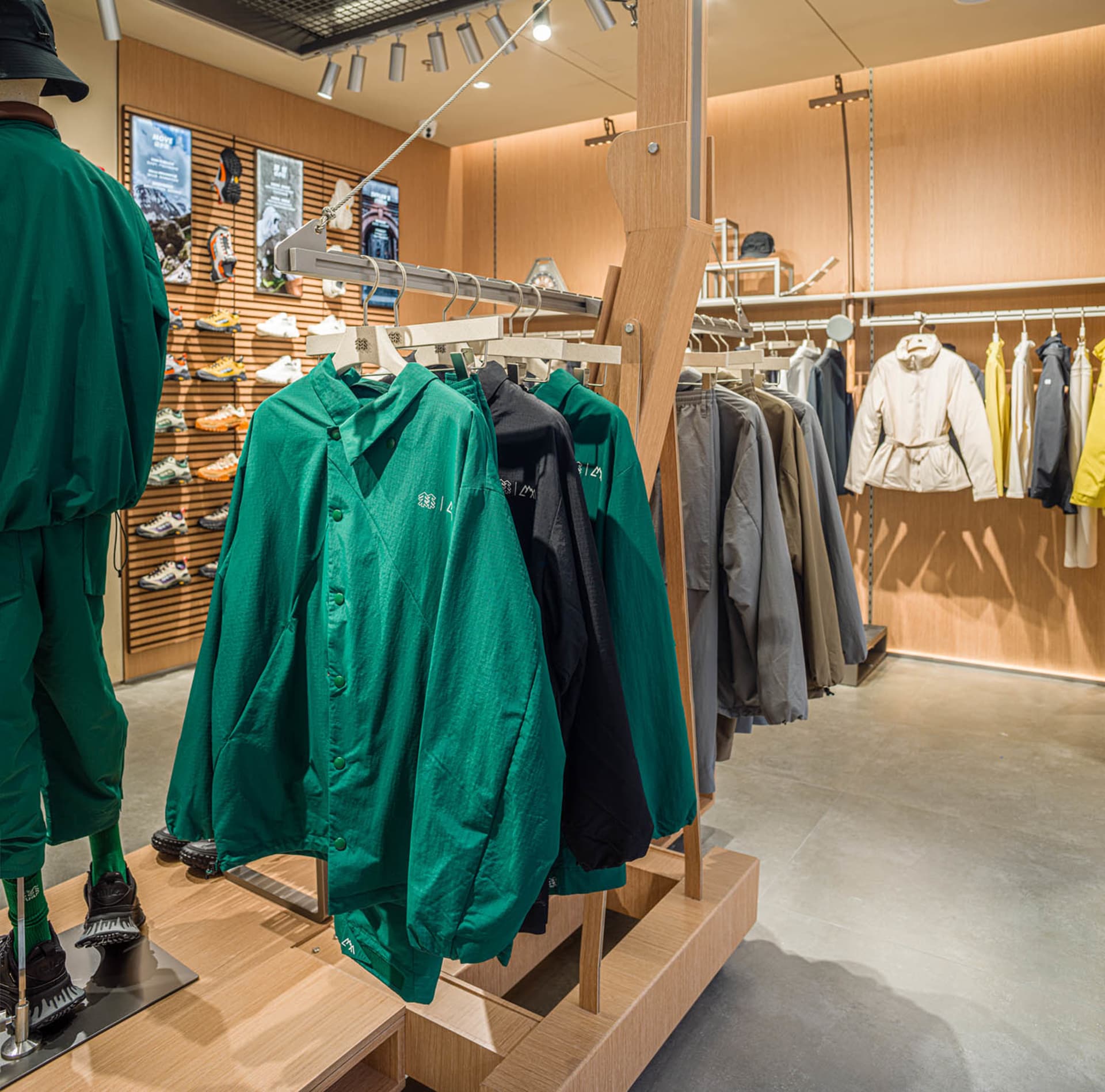 Retail store with modern design featuring clothing racks and shoe display.