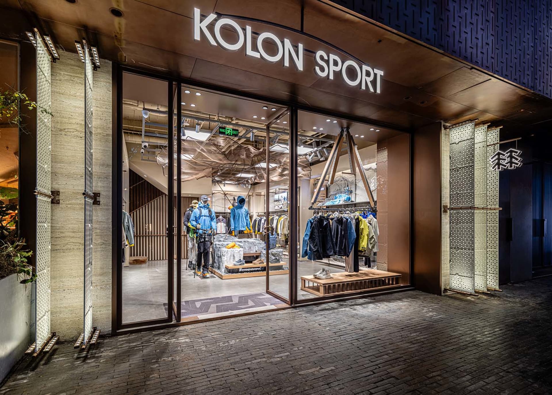 Modern retail storefront with large glass windows and metallic accents.