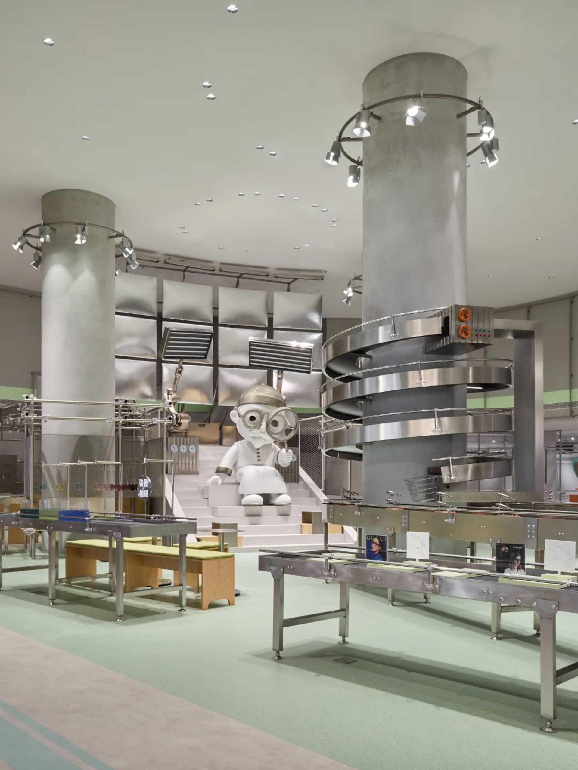 An industrial retail space featuring a large conveyor belt and metallic structural elements.