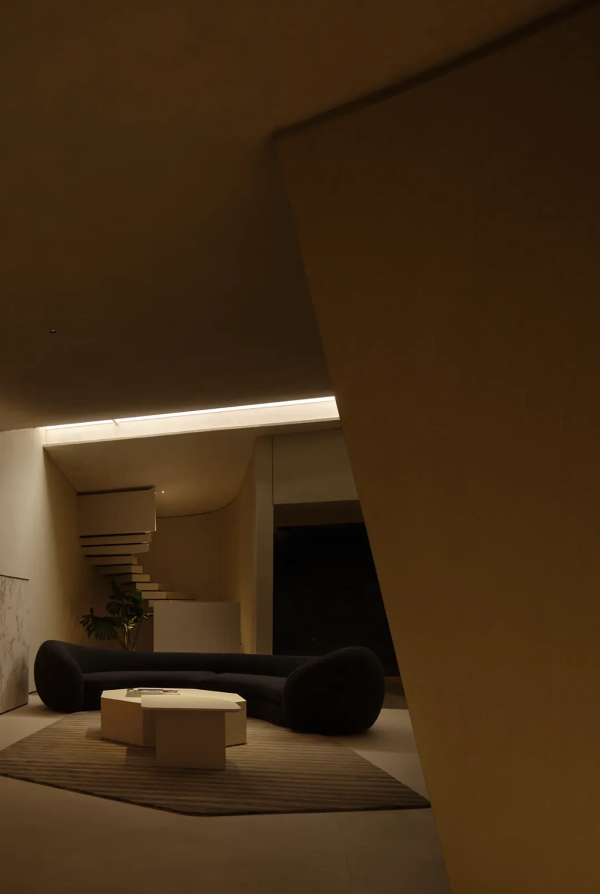 Modern living room featuring a contemporary concrete couch and minimalist coffee table.