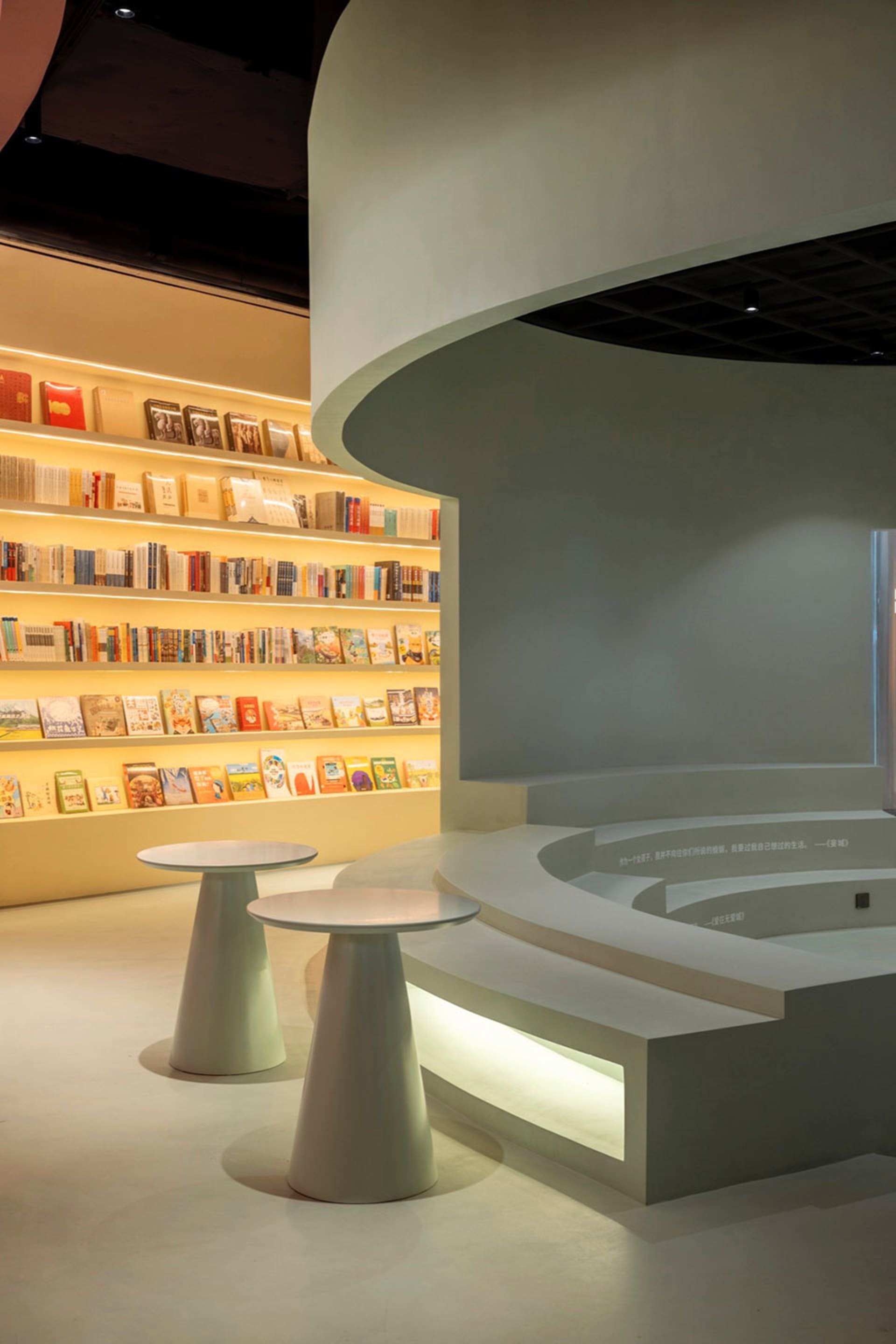 A modern bookstore with round counters and curved bookshelves.