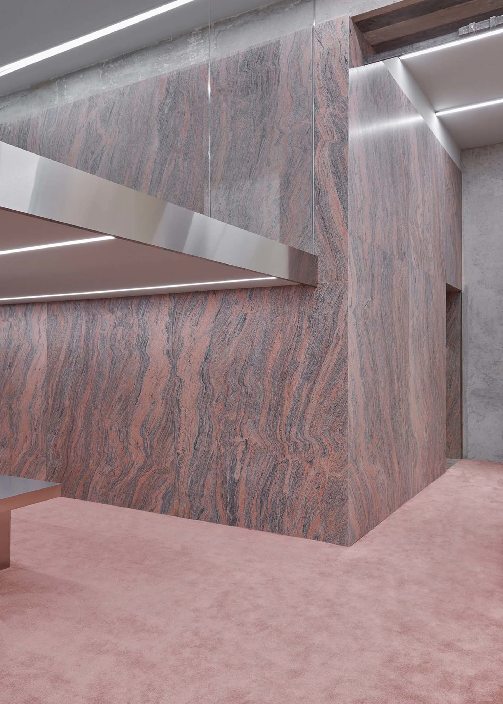 Modern office lobby featuring granite flooring and minimalist design elements.