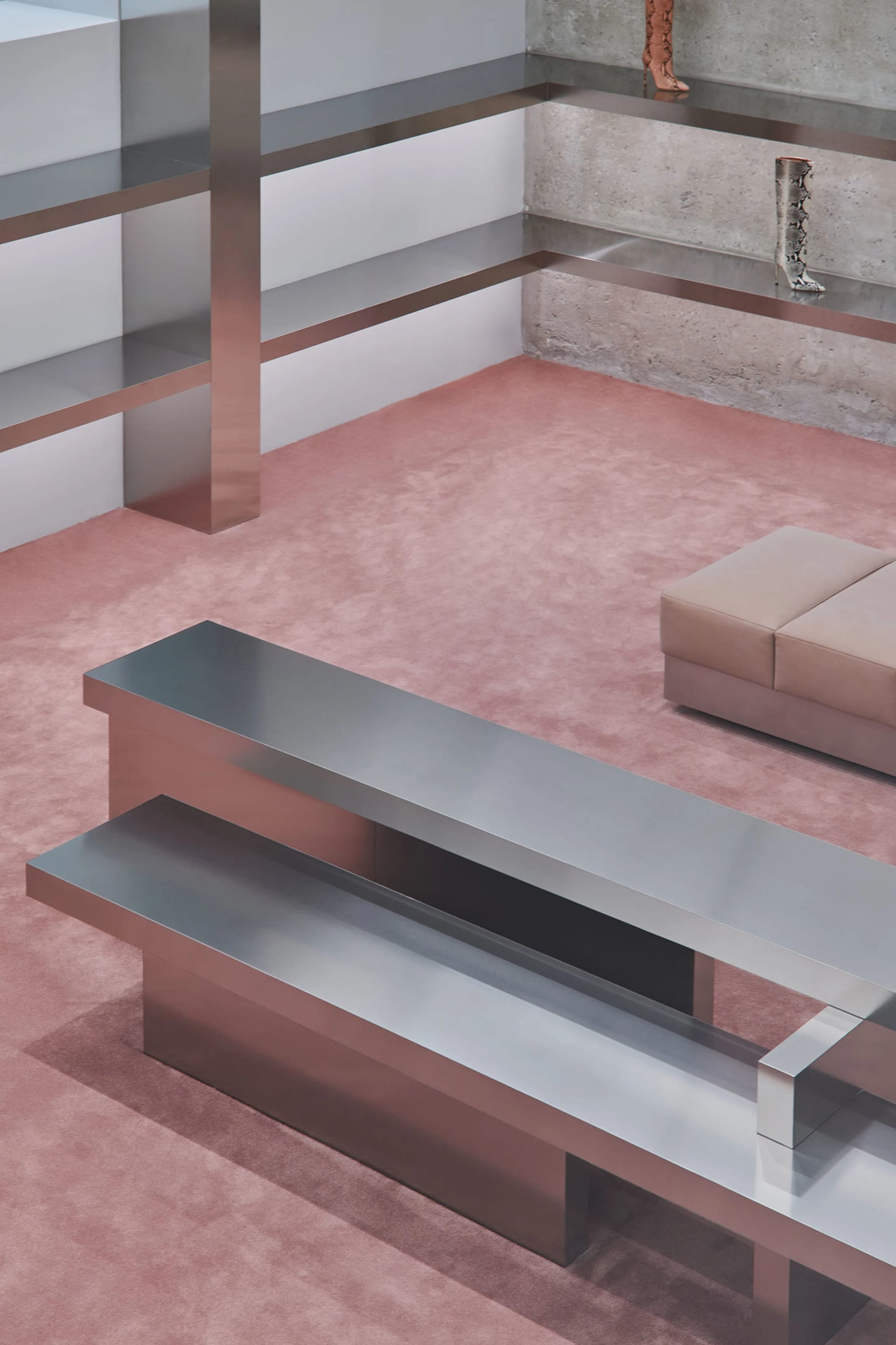 A modern interior featuring metallic furniture on a pink carpet.