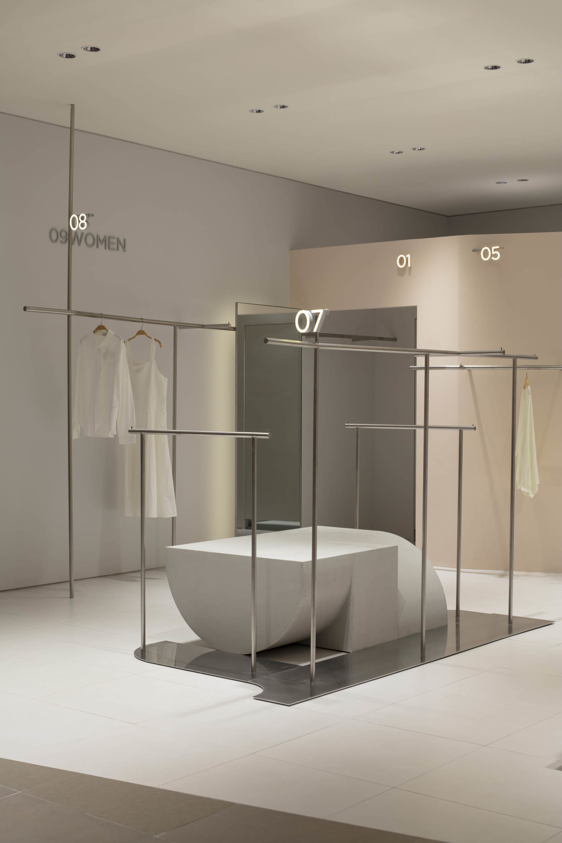 A modern retail shop with white concrete and metal elements.
