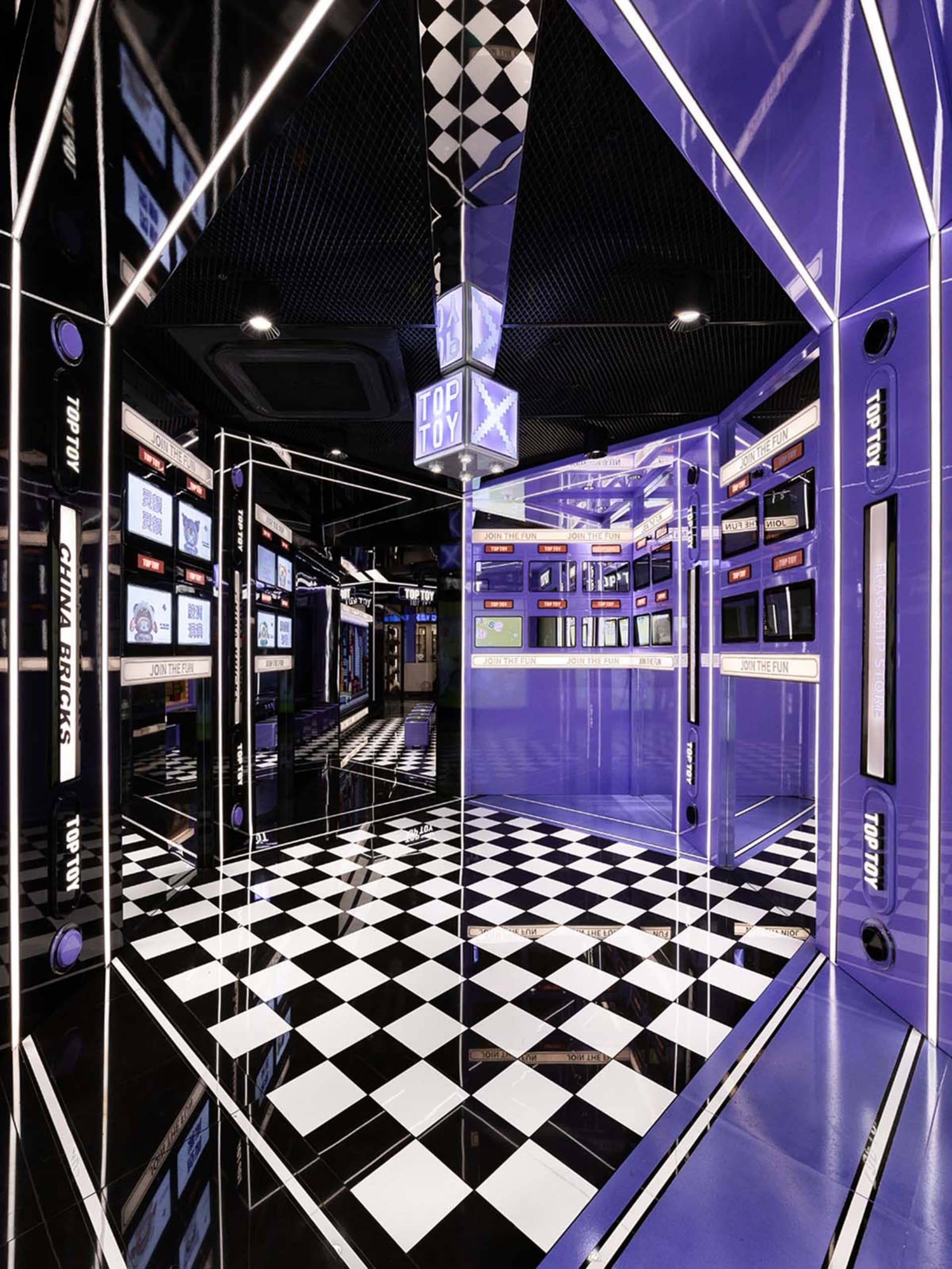 A modern retail space with glass walls and a checkered floor, featuring a purple color scheme.