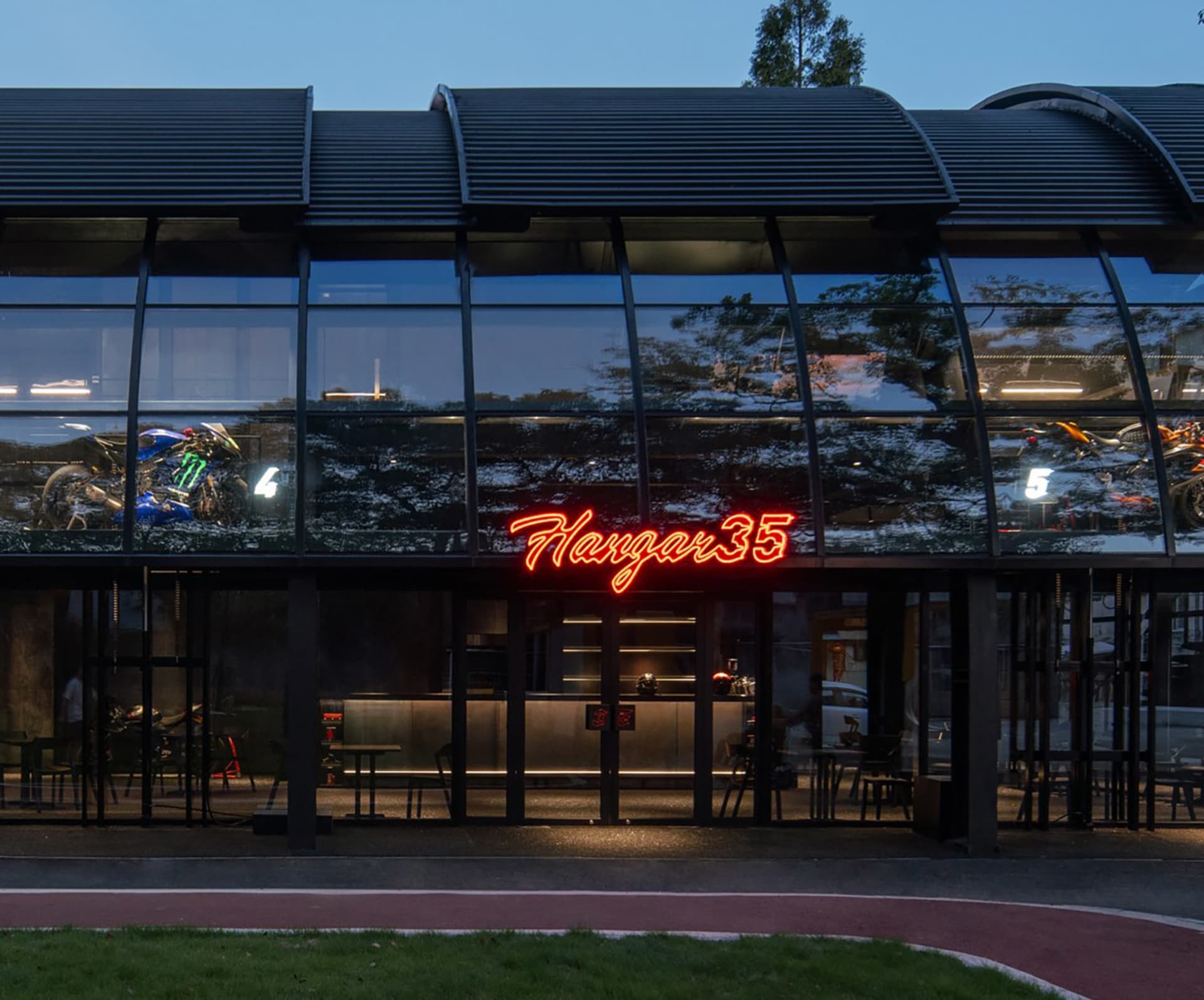 Modern storefront with metal, glass, and neon signage