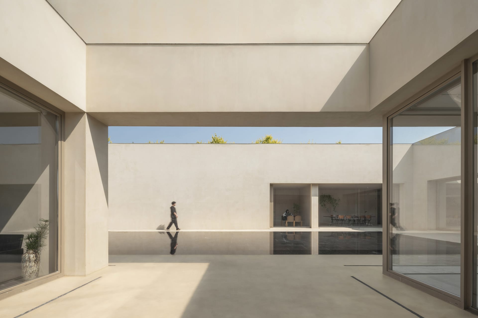A modern interior space with concrete walls and flooring, featuring a minimalist design.