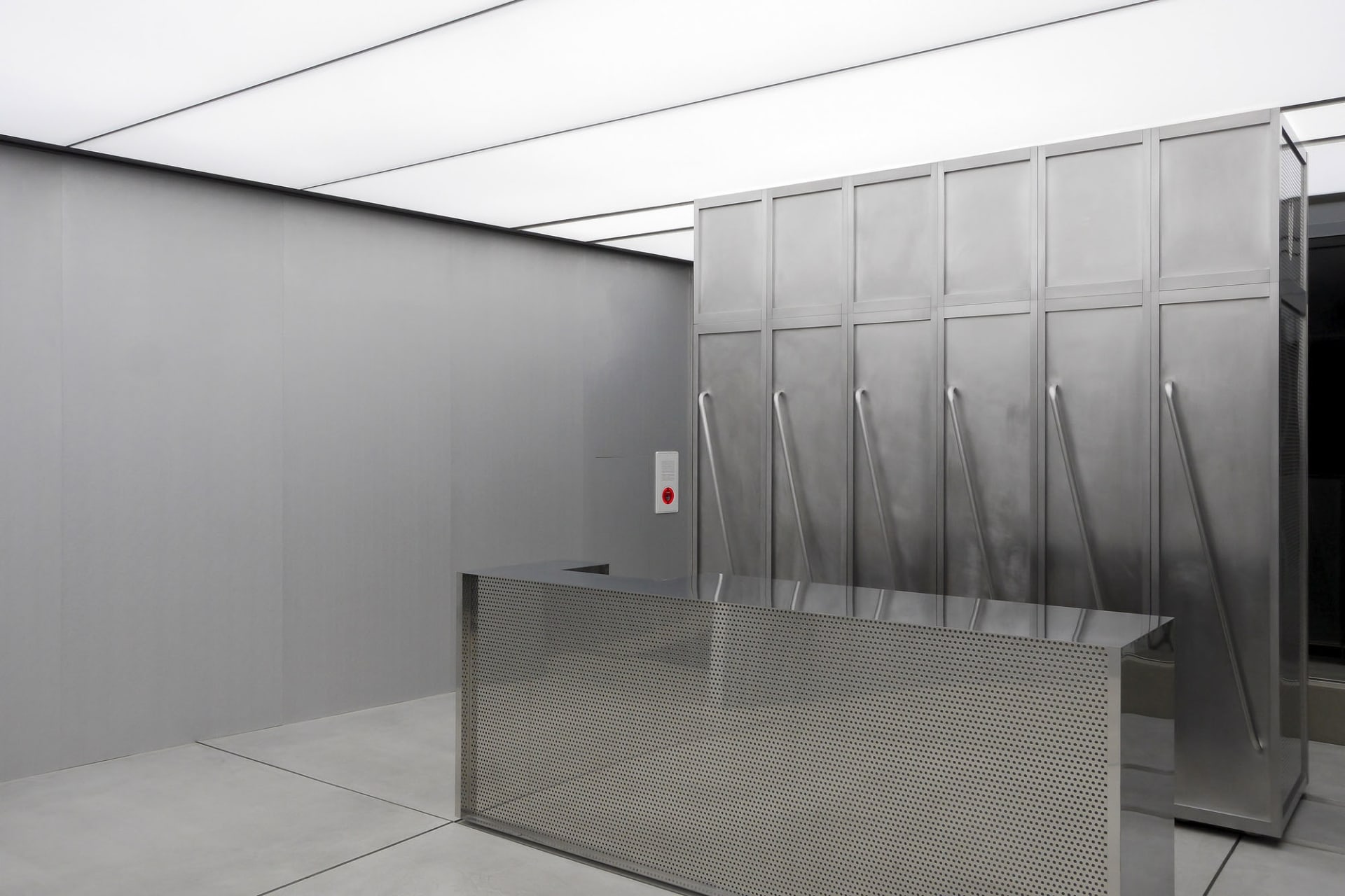 Modern industrial-style lobby with metallic finishes and glass elements